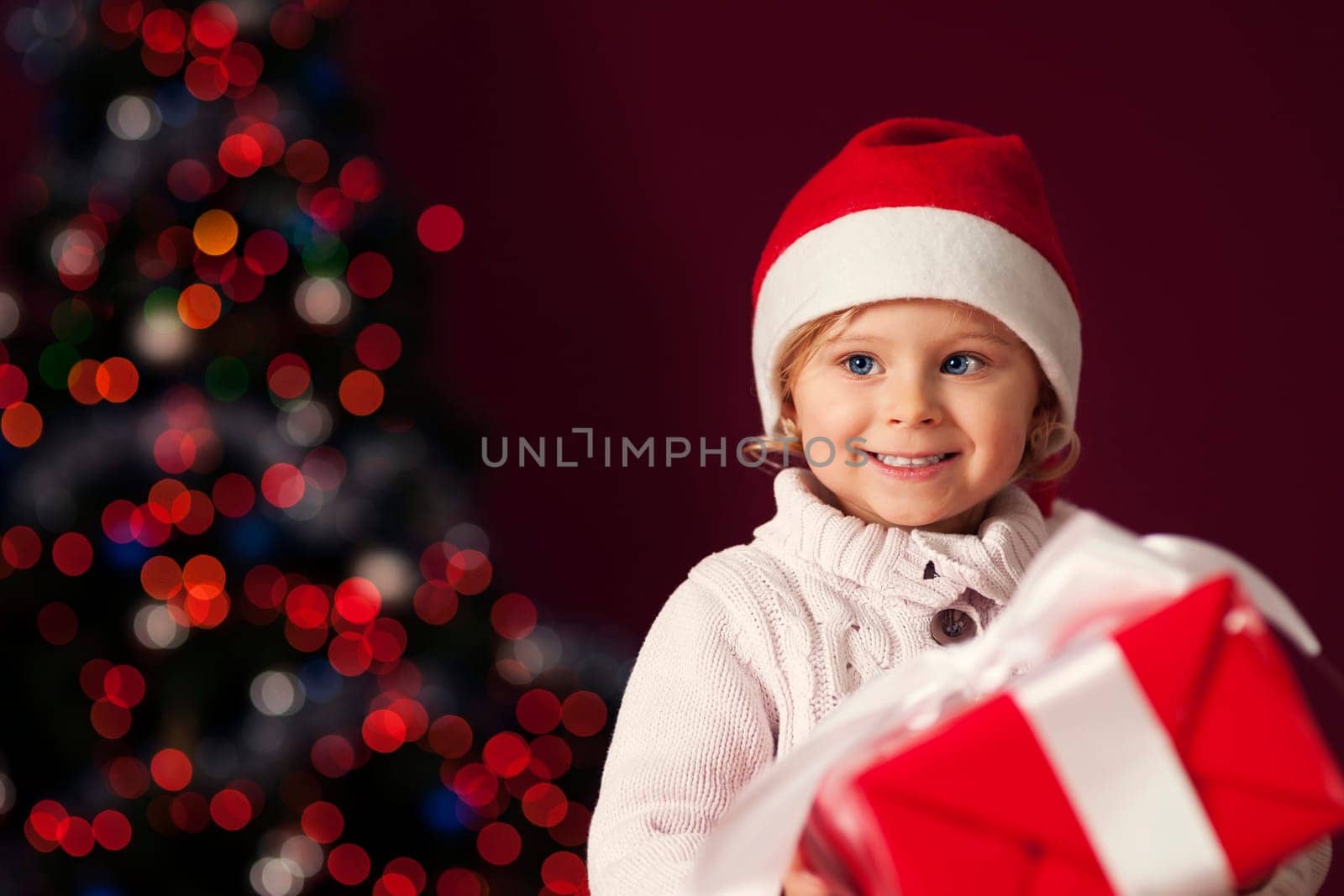Little girl holding red gift box