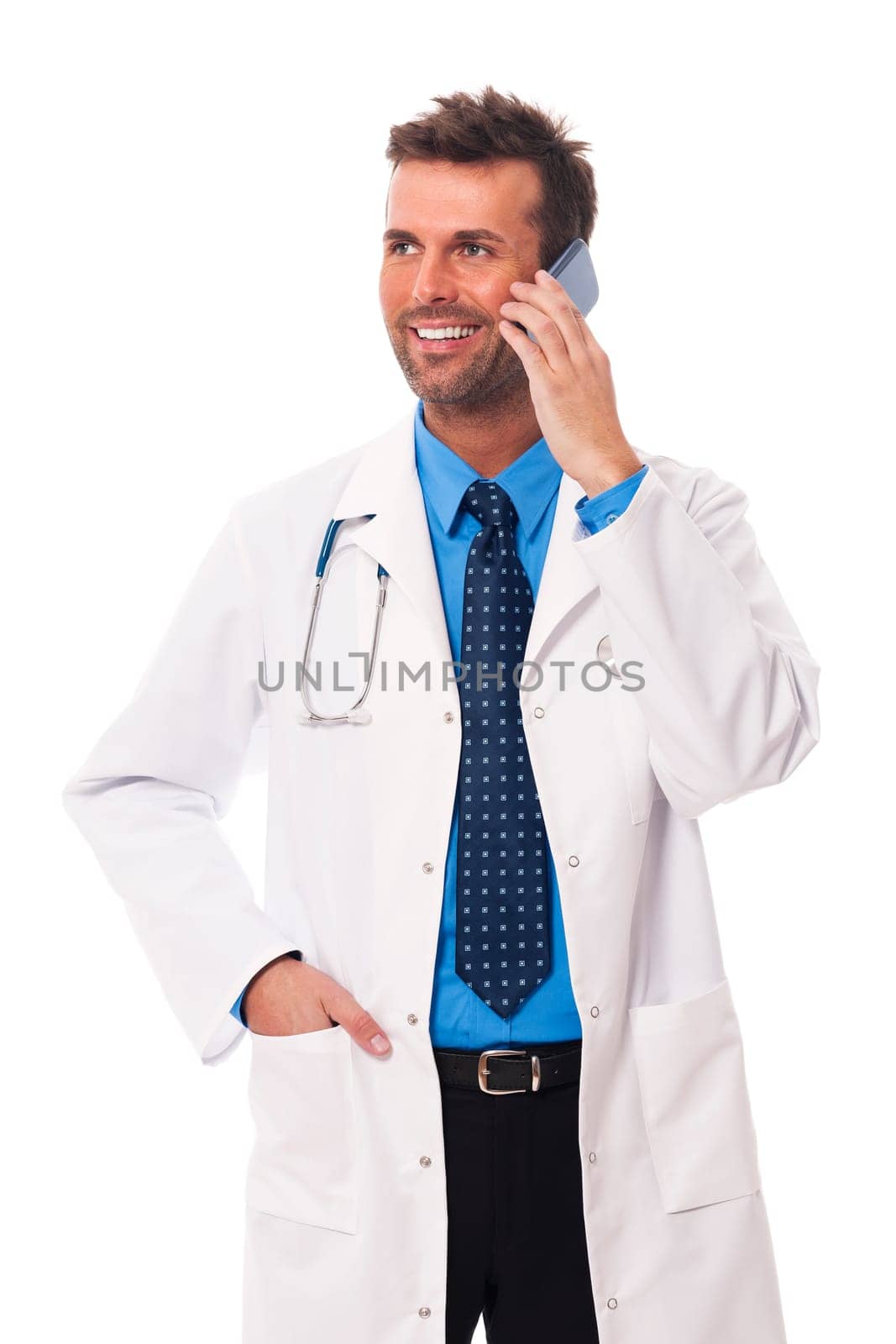 Smiling male doctor talking on mobile phone