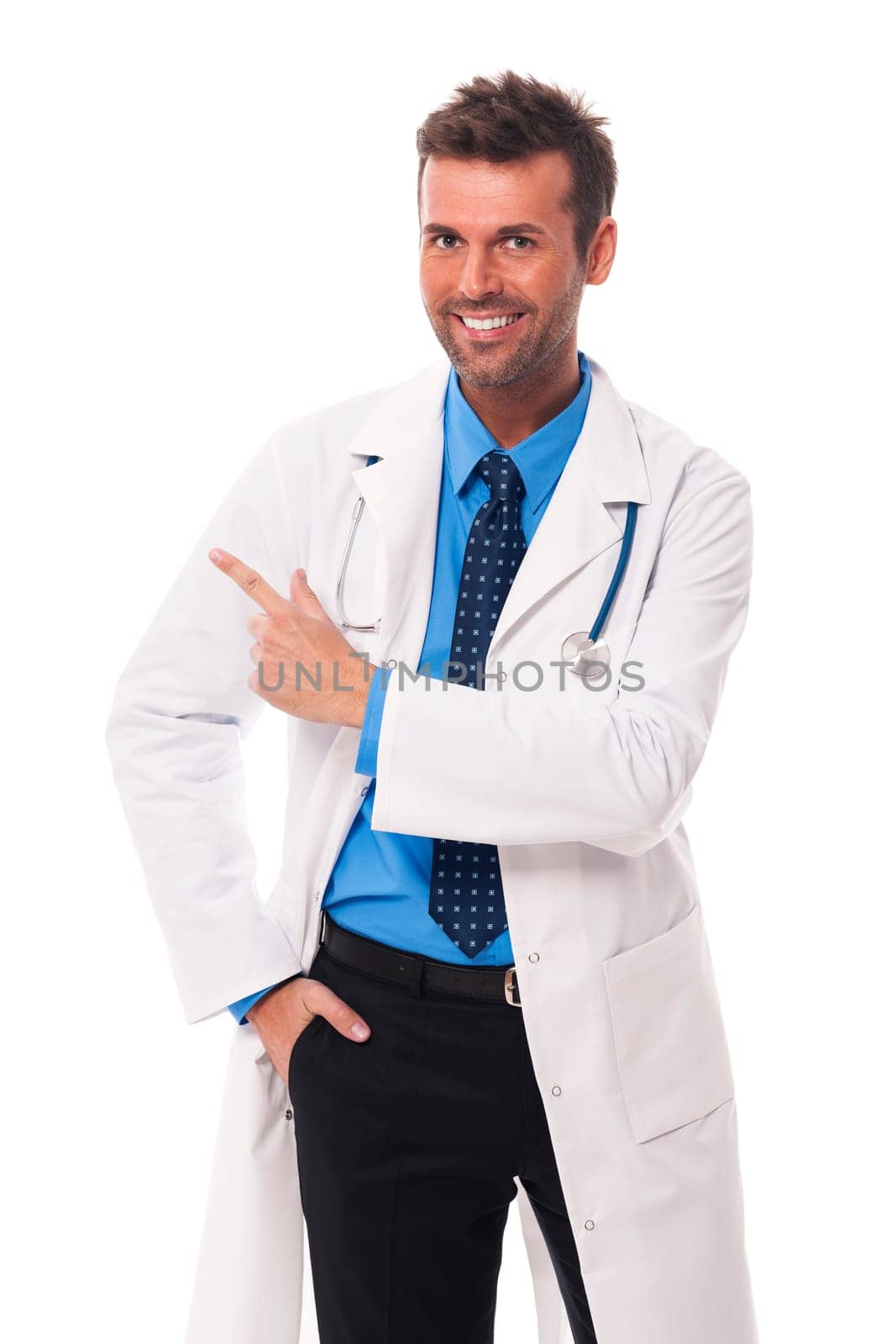 Happy doctor pointing at copy space