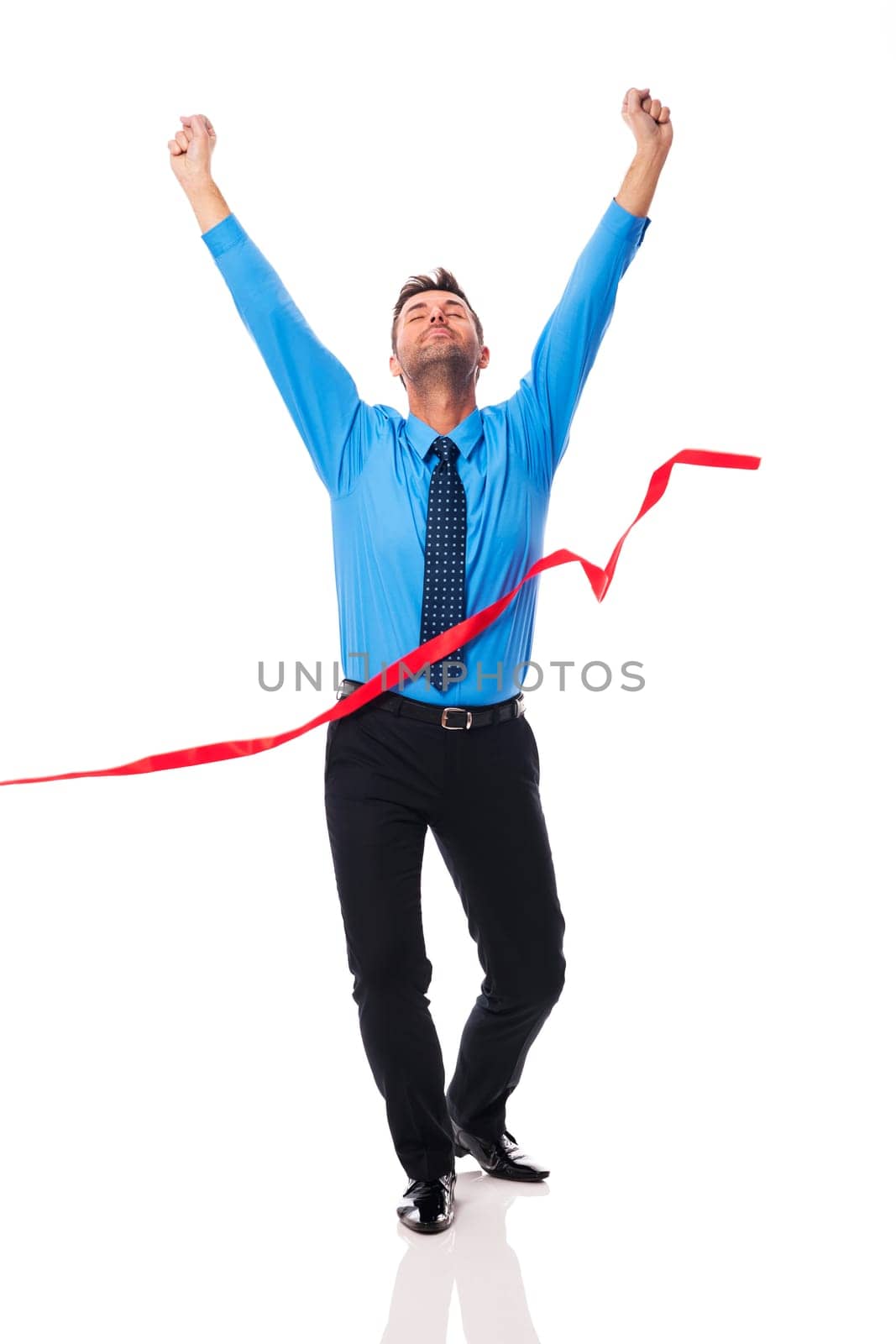 Handsome business man crossing the finish line