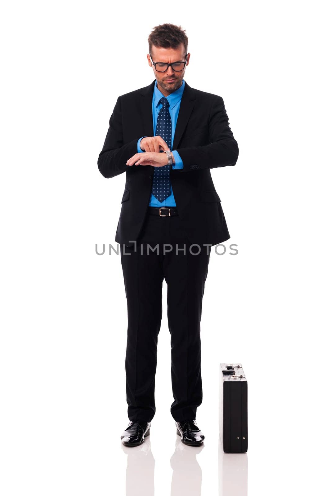 Businessman checking time on watch