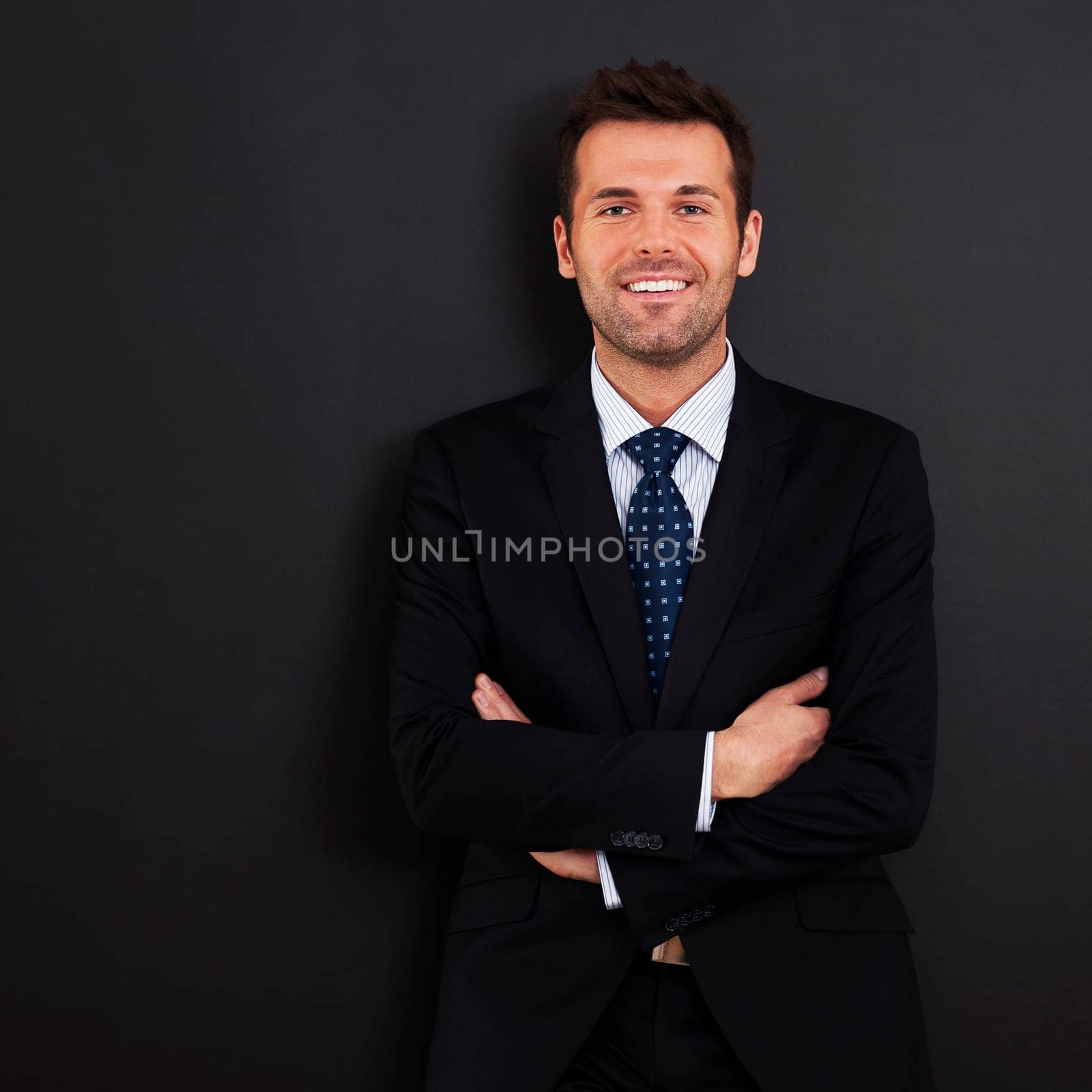 Smiling businessman with arms crossed