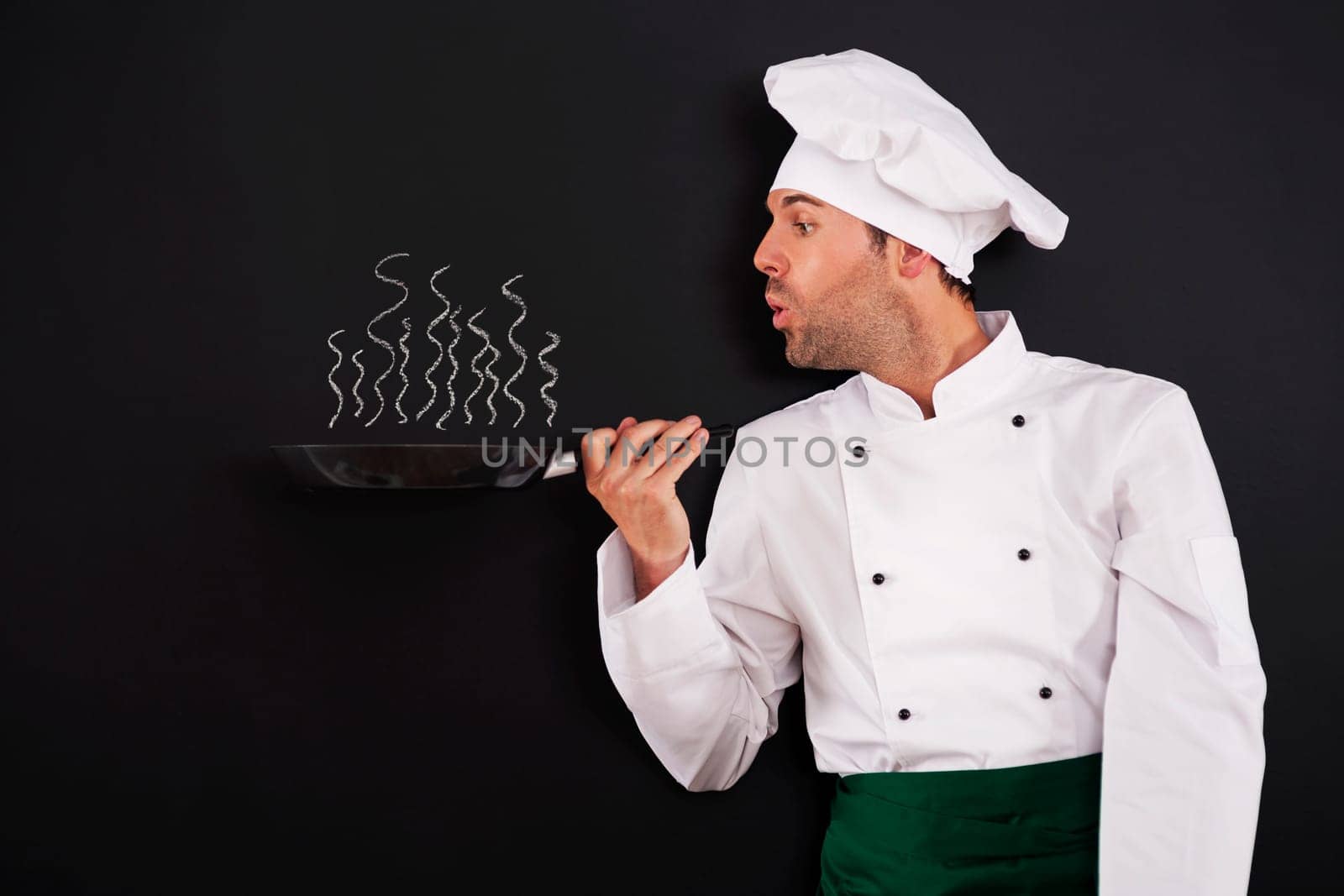 Chef blowing smoke from pan