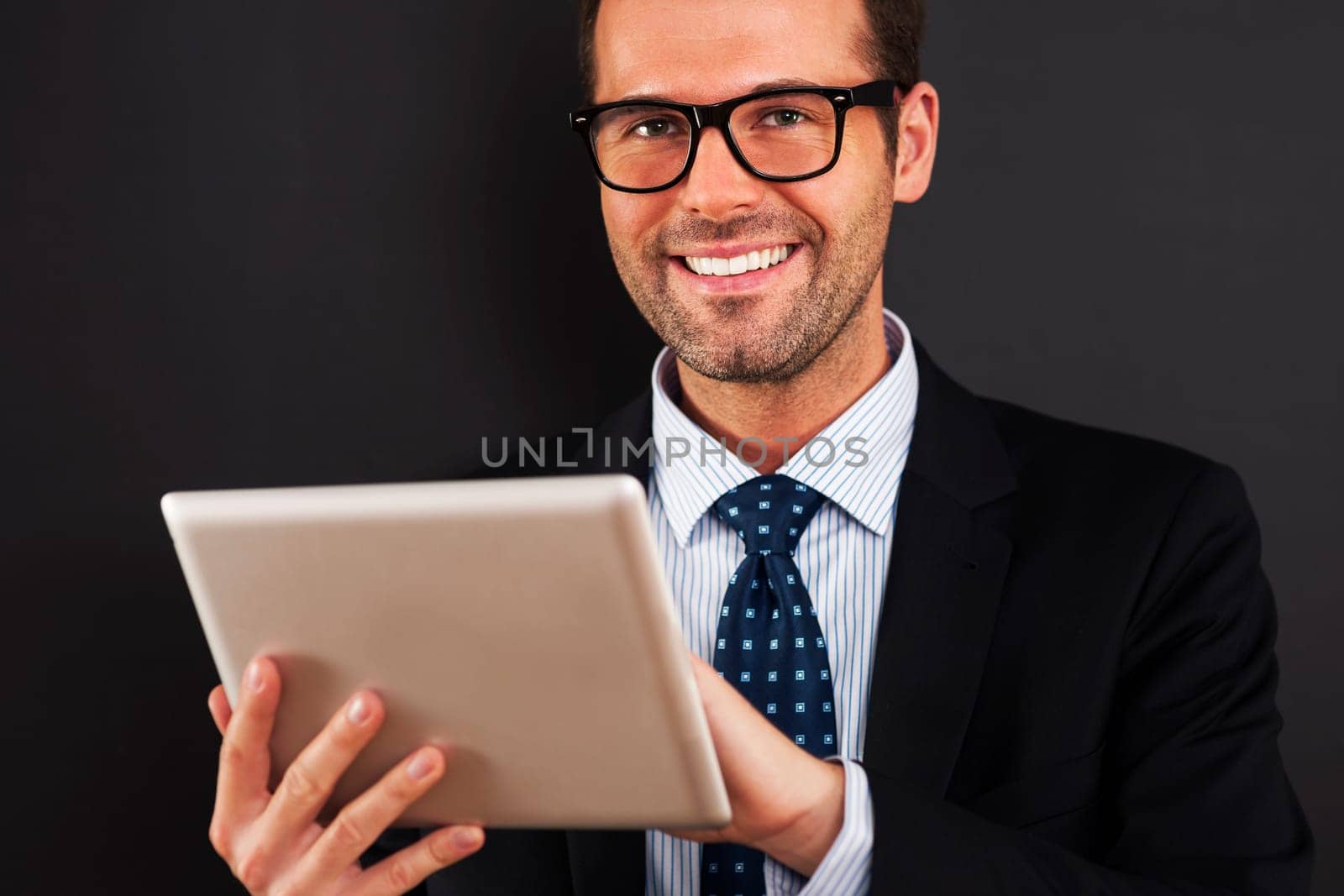 Businessman wearing glasses using digital tablet