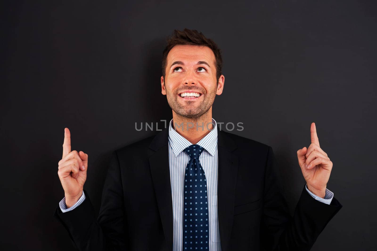Businessman pointing up on copy space