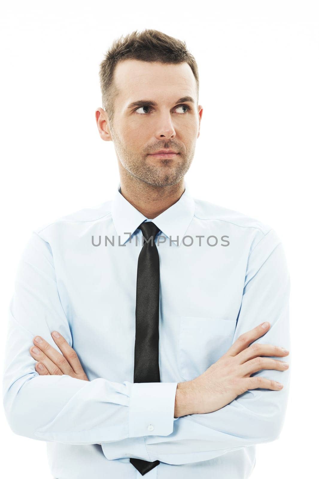 Handsome businessman with arms crossed looking away