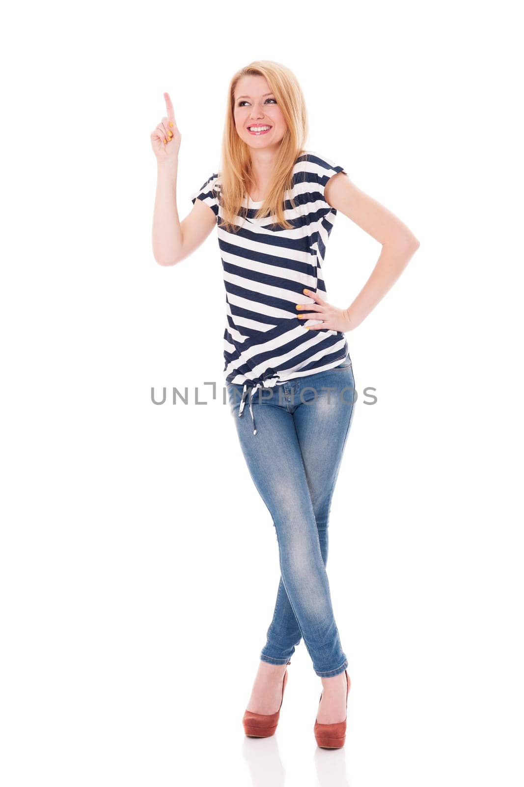 Happy woman in striped blouse pointing at copyspace