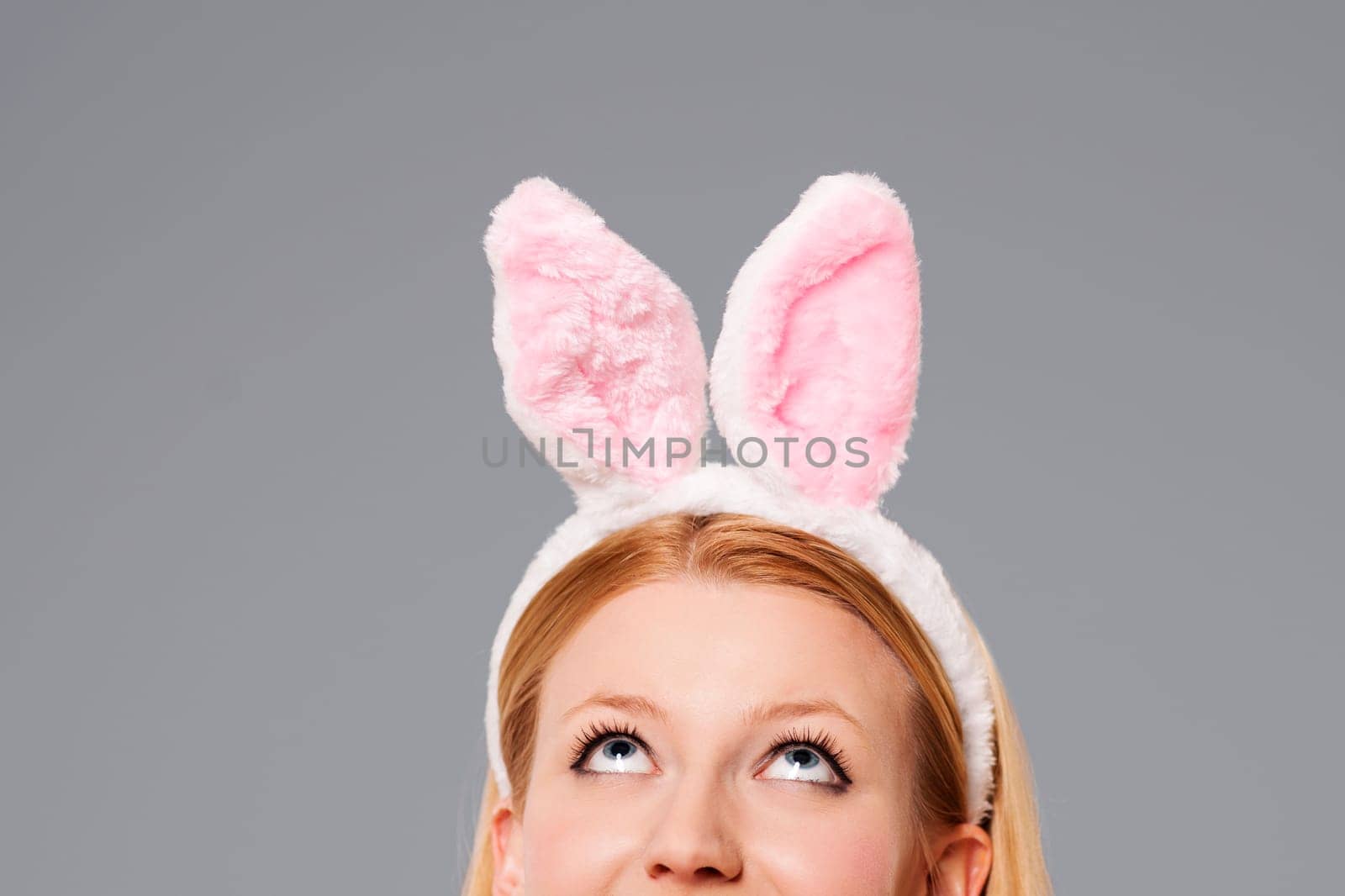 Easter bunny woman looking up