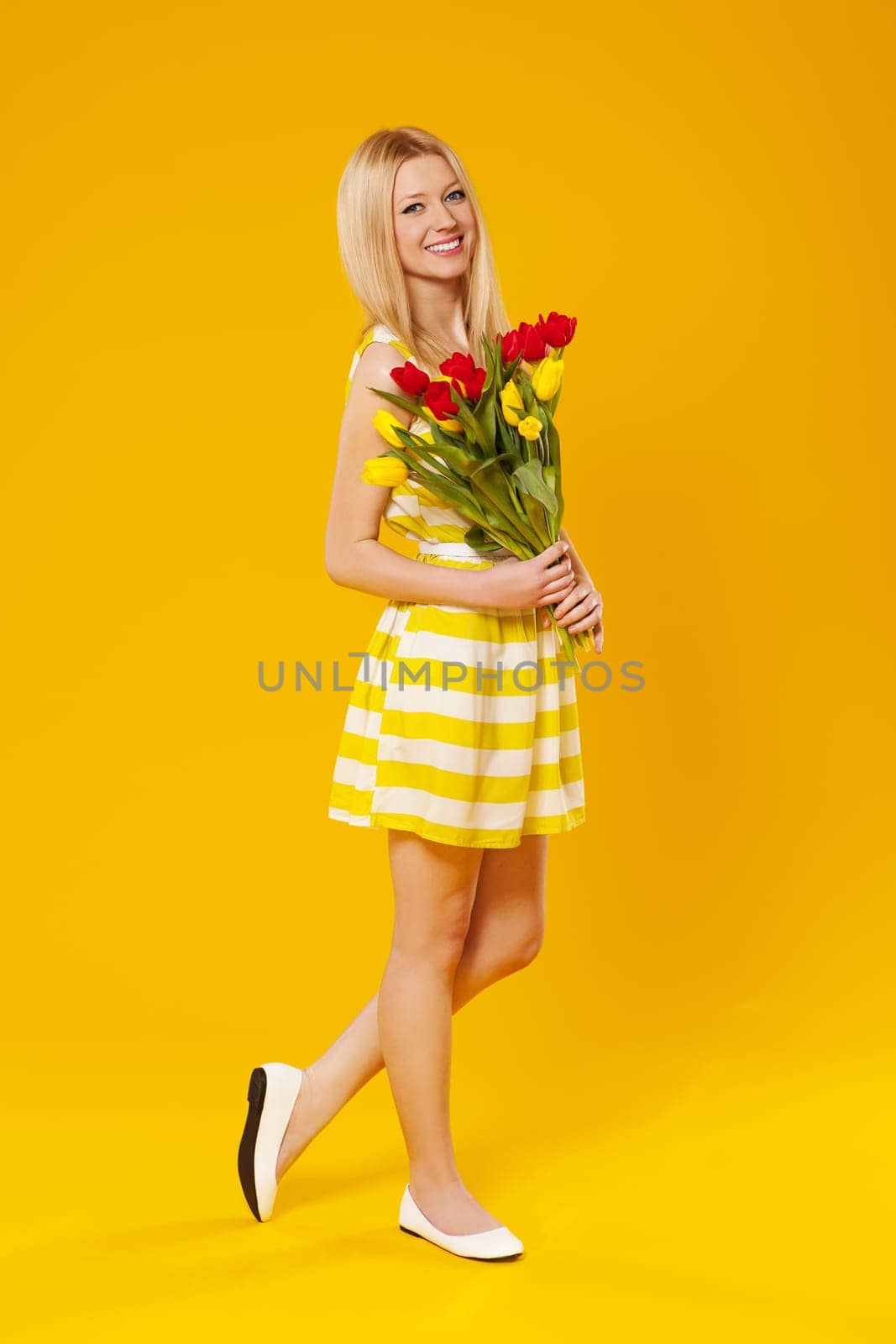 Blonde woman holding bouquet of spring flower