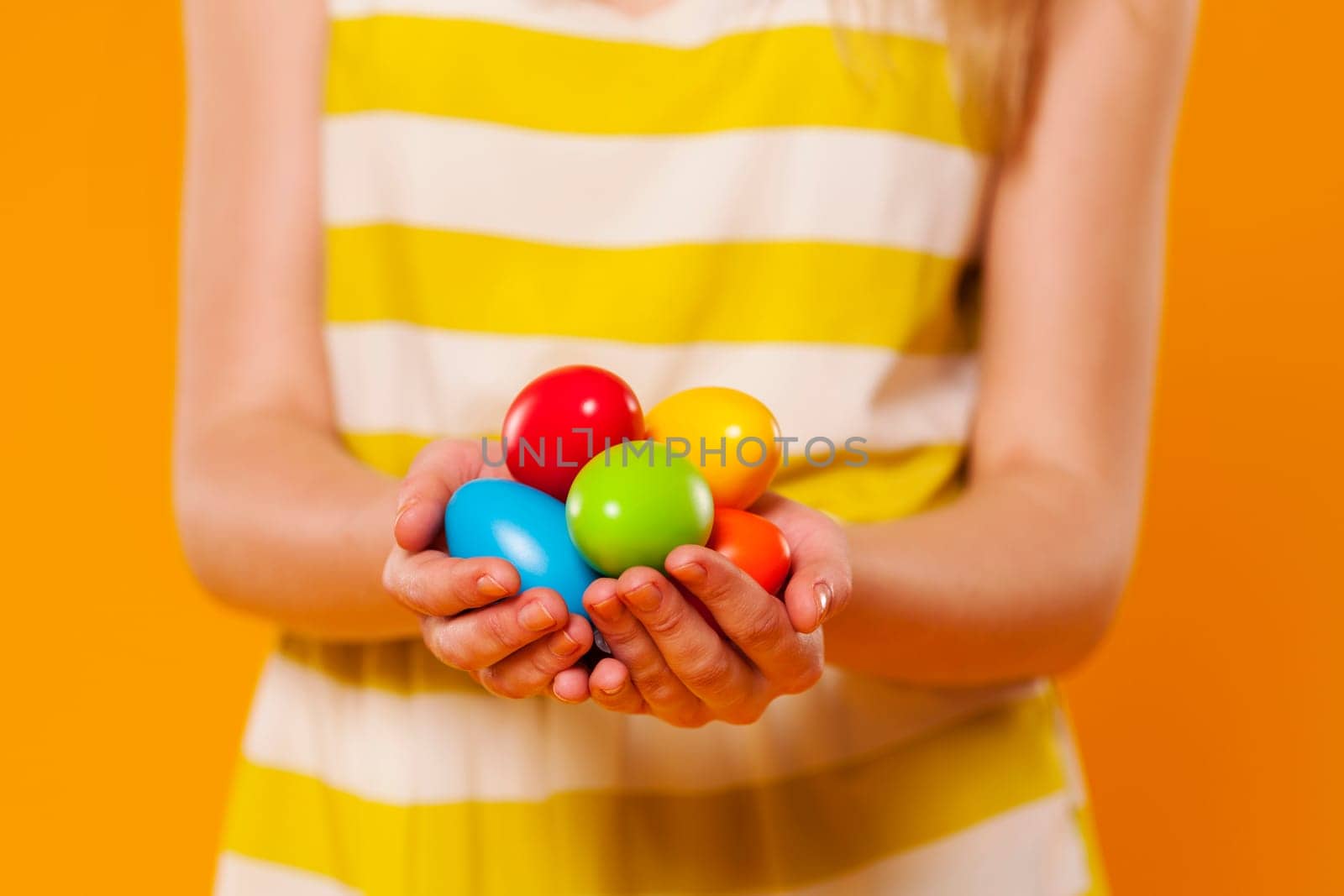 Close-up of multi colored easter egg in hands