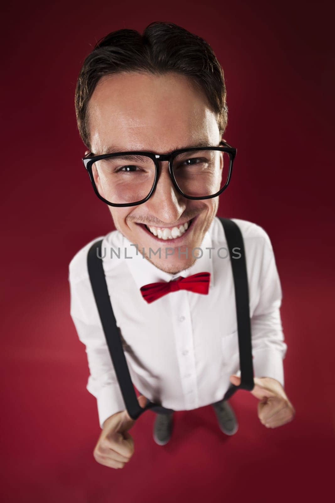 Portrait of nerdy man wearing red bow tie and suspenders
