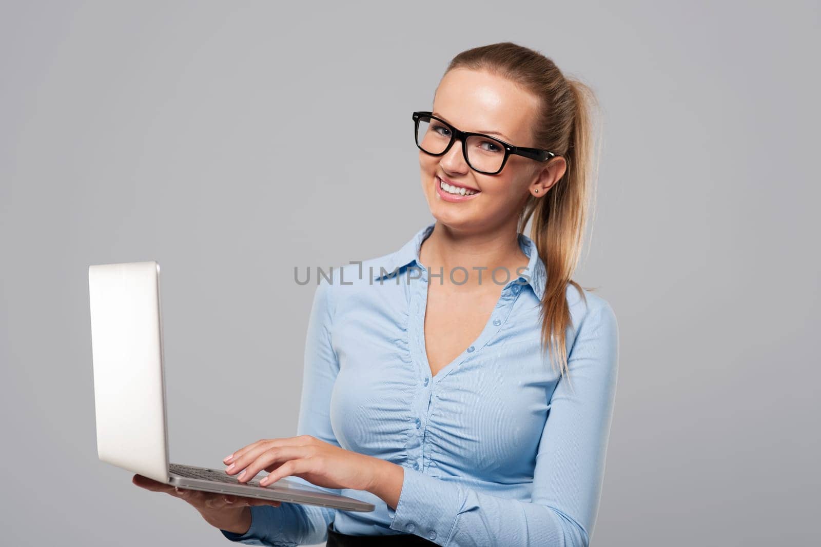 Beautiful young businesswoman using laptop