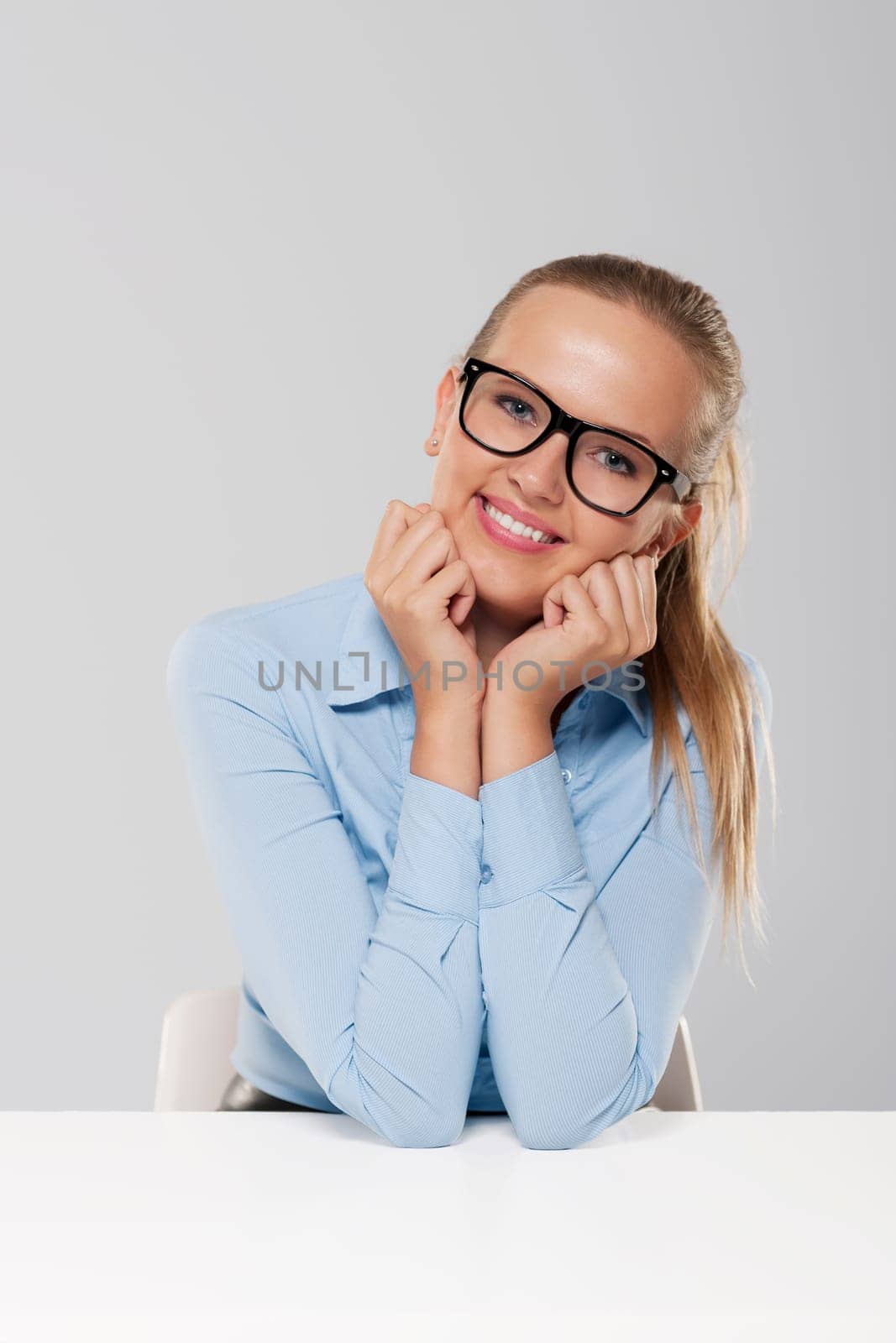 Portrait of cute sitting blond businesswoman
