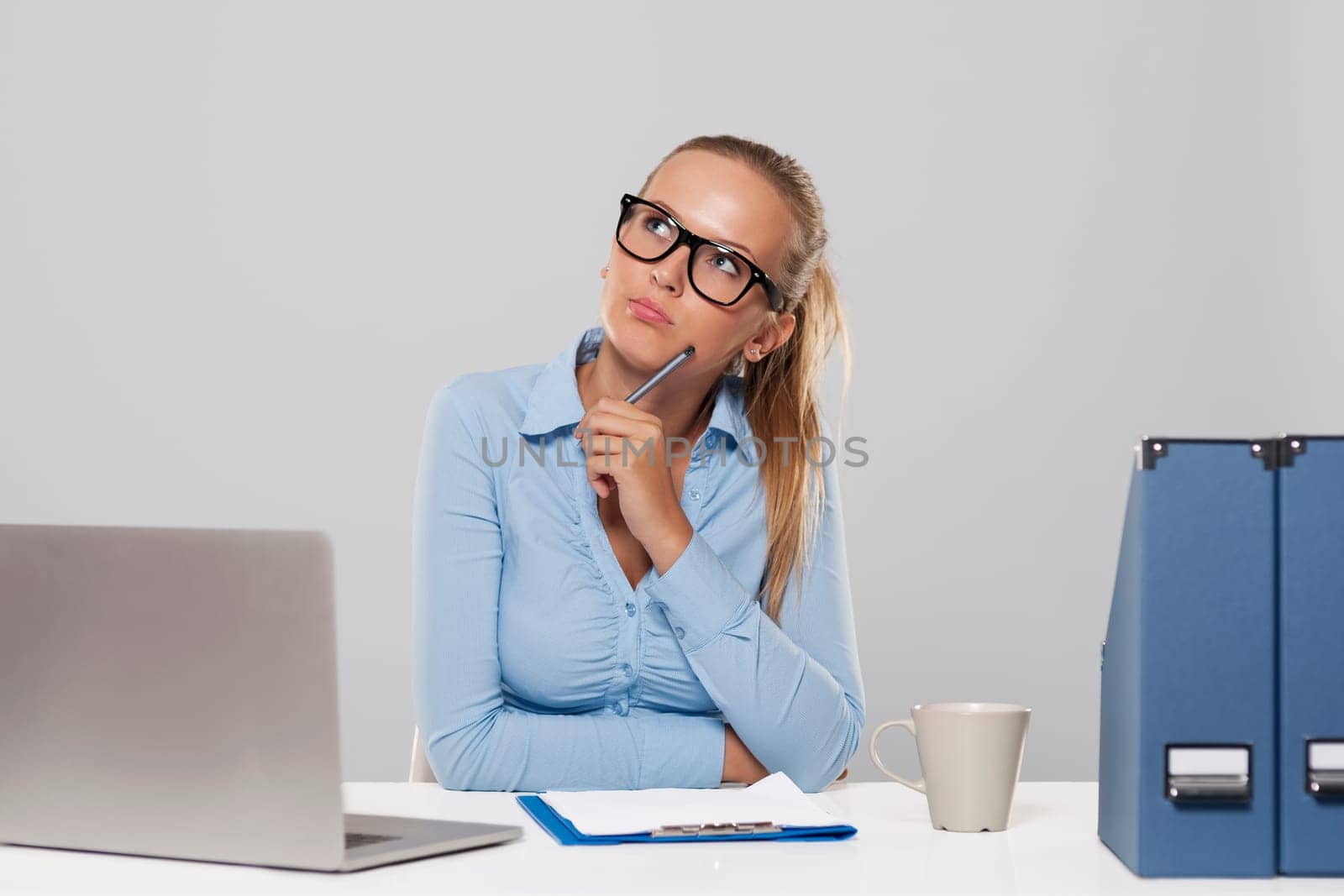 Thoughtful businesswoman sitting at office