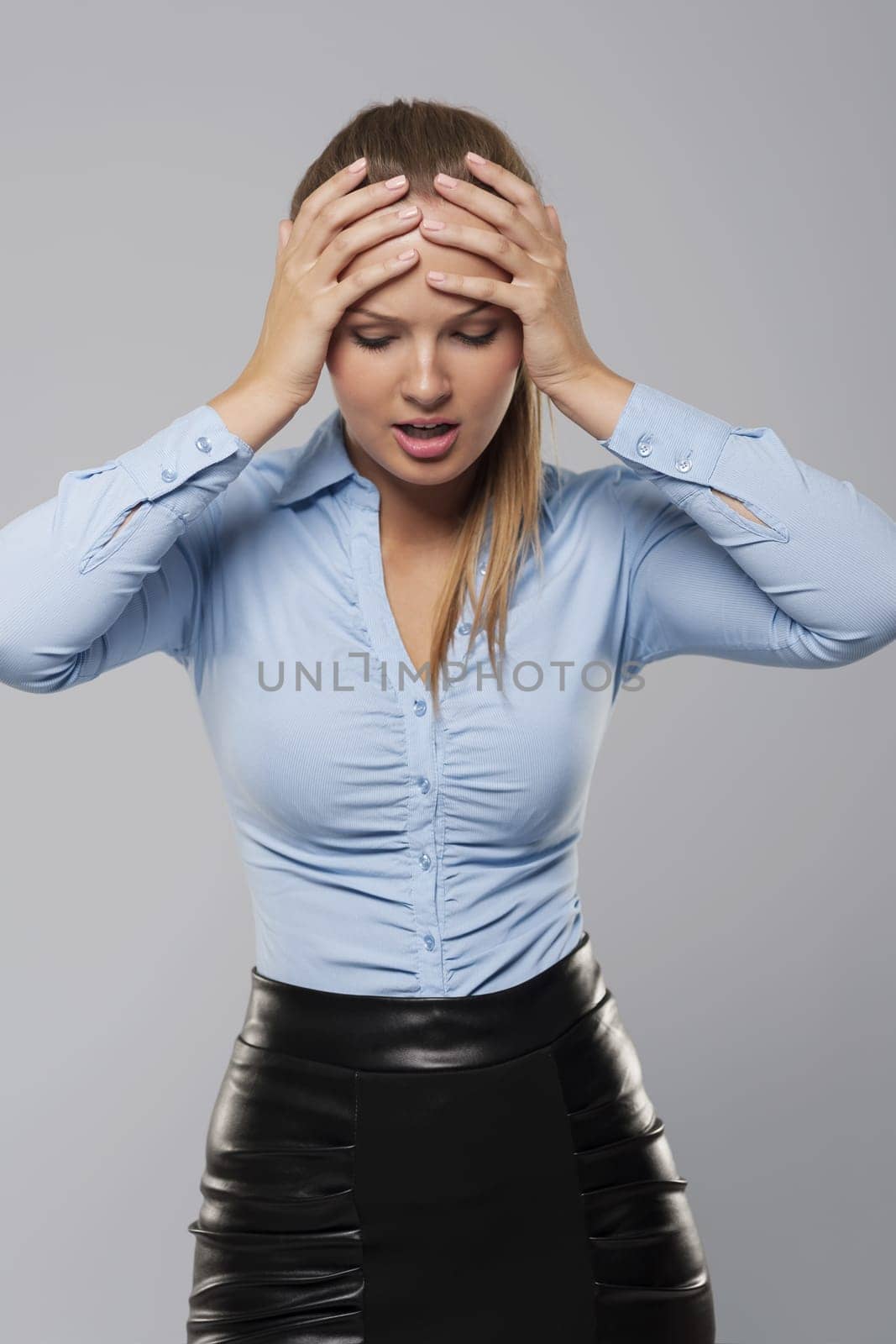 Terrified businesswoman covering hand on her head