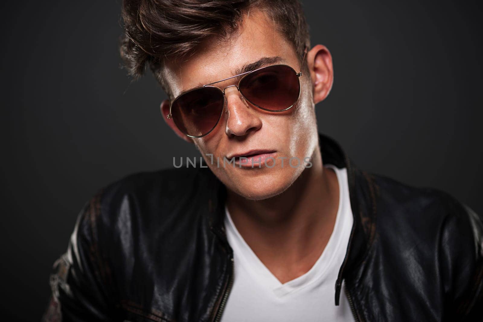 Portrait of bad boy wearing glasses