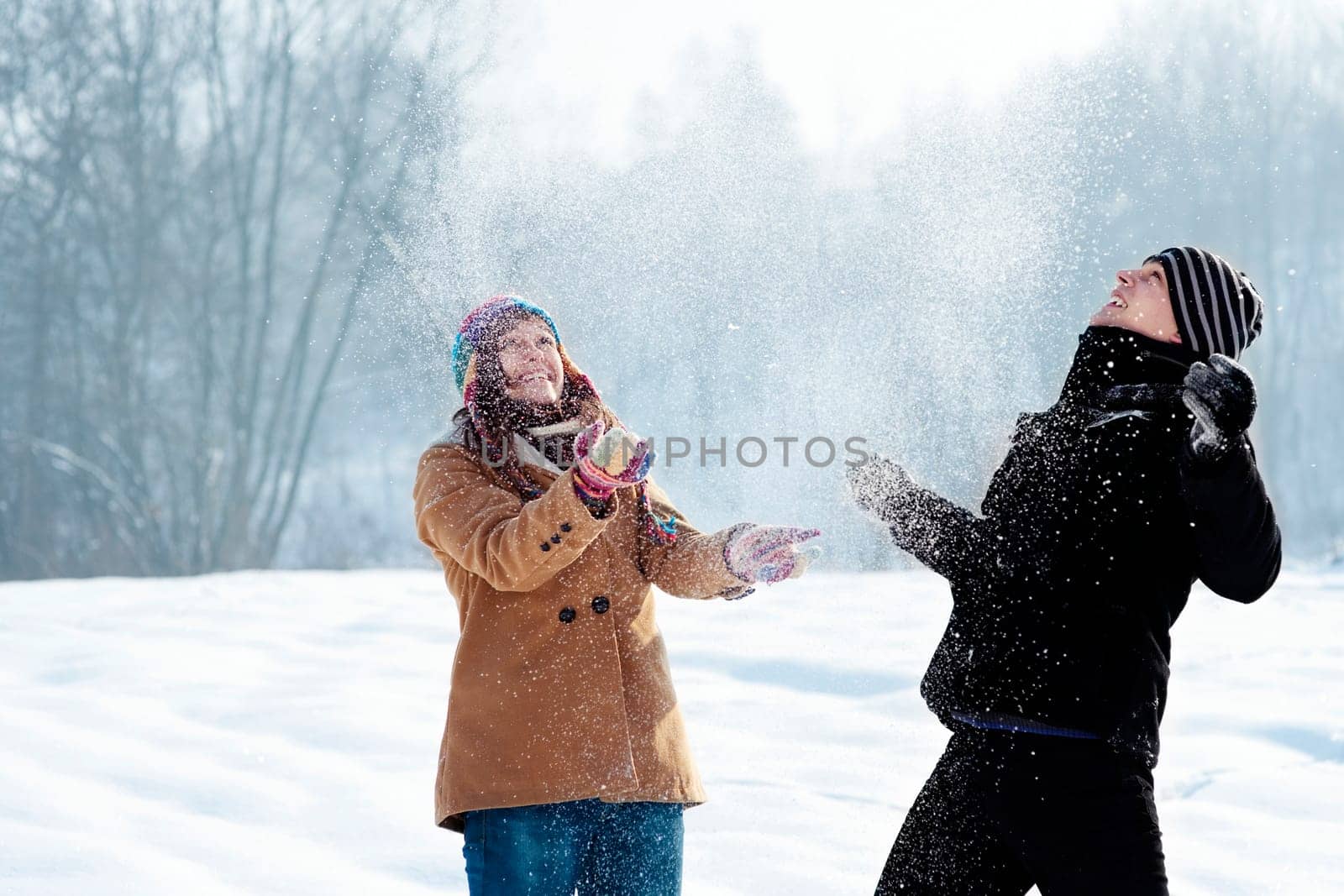 Young couple playing with snow
