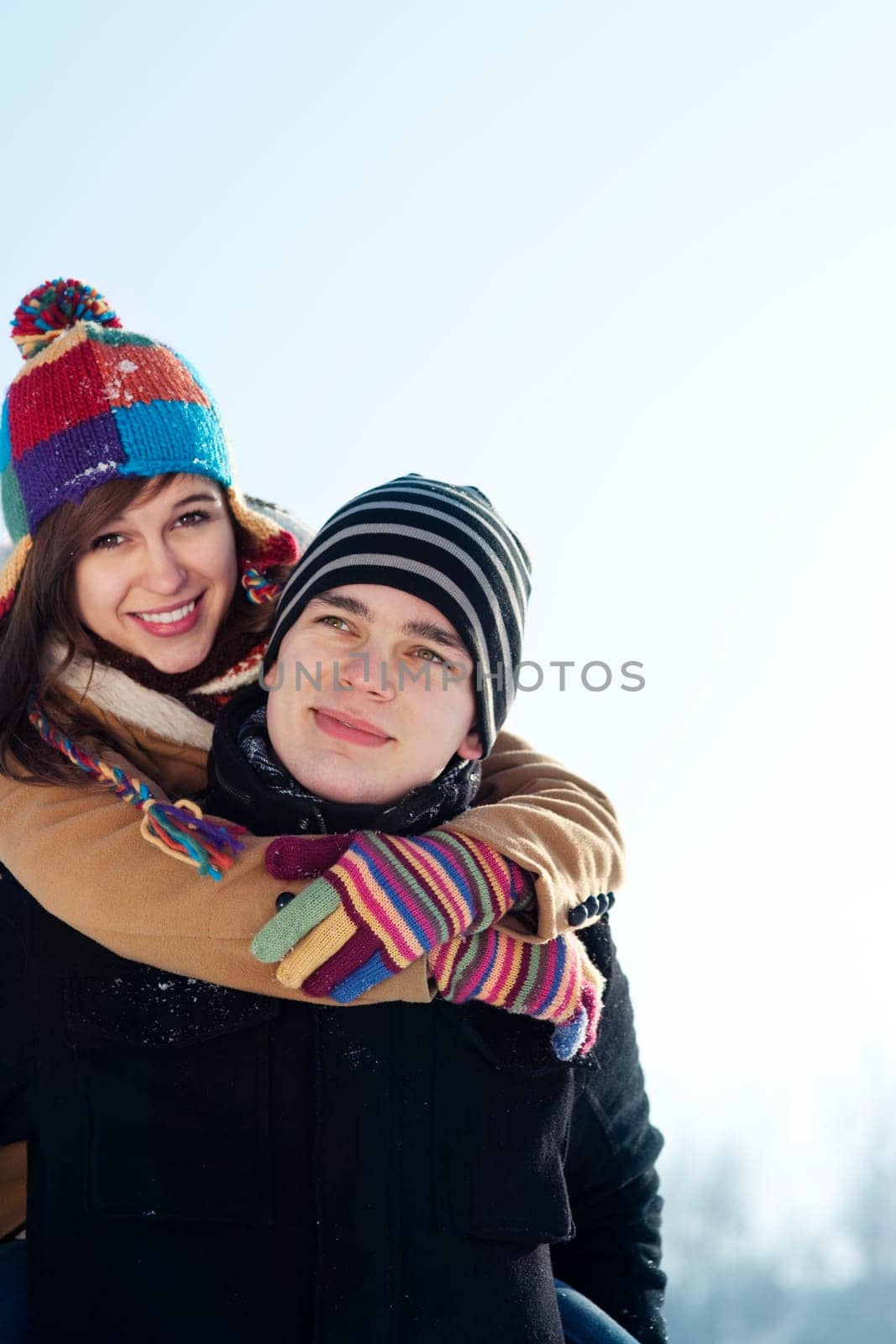 Young man giving his girlfriend a piggyback ride