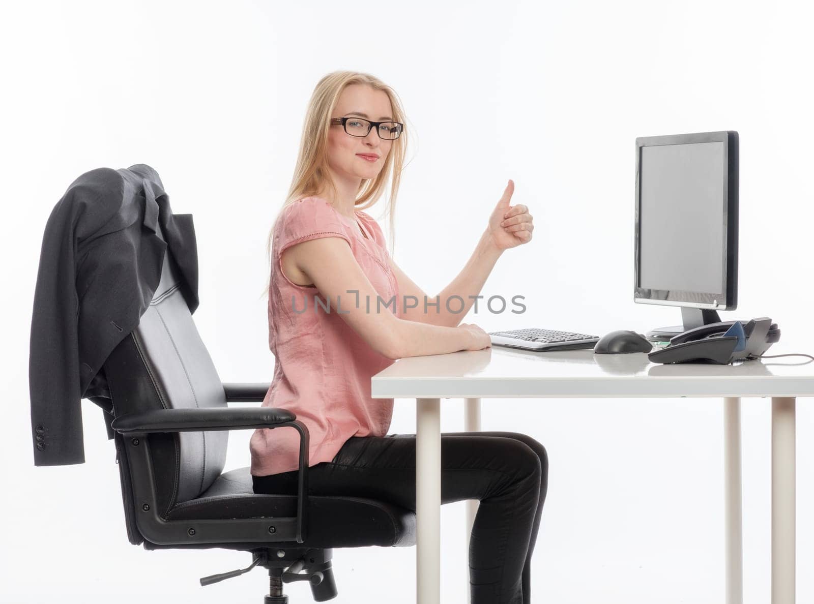 Woman in the office shows thumbs up