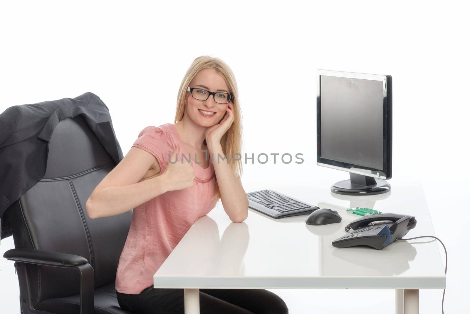 Woman in the office shows thumbs up