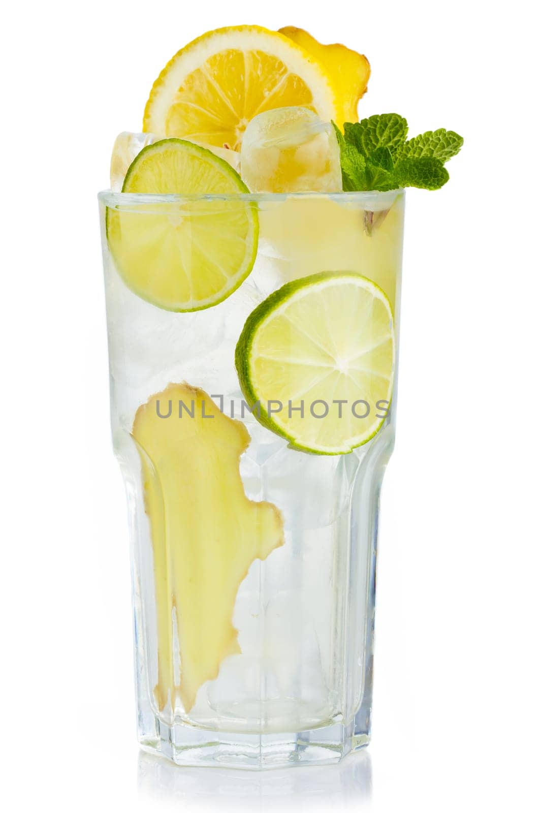 Full glass of fresh birch juice with lemon, ginger and mint leaves isolated