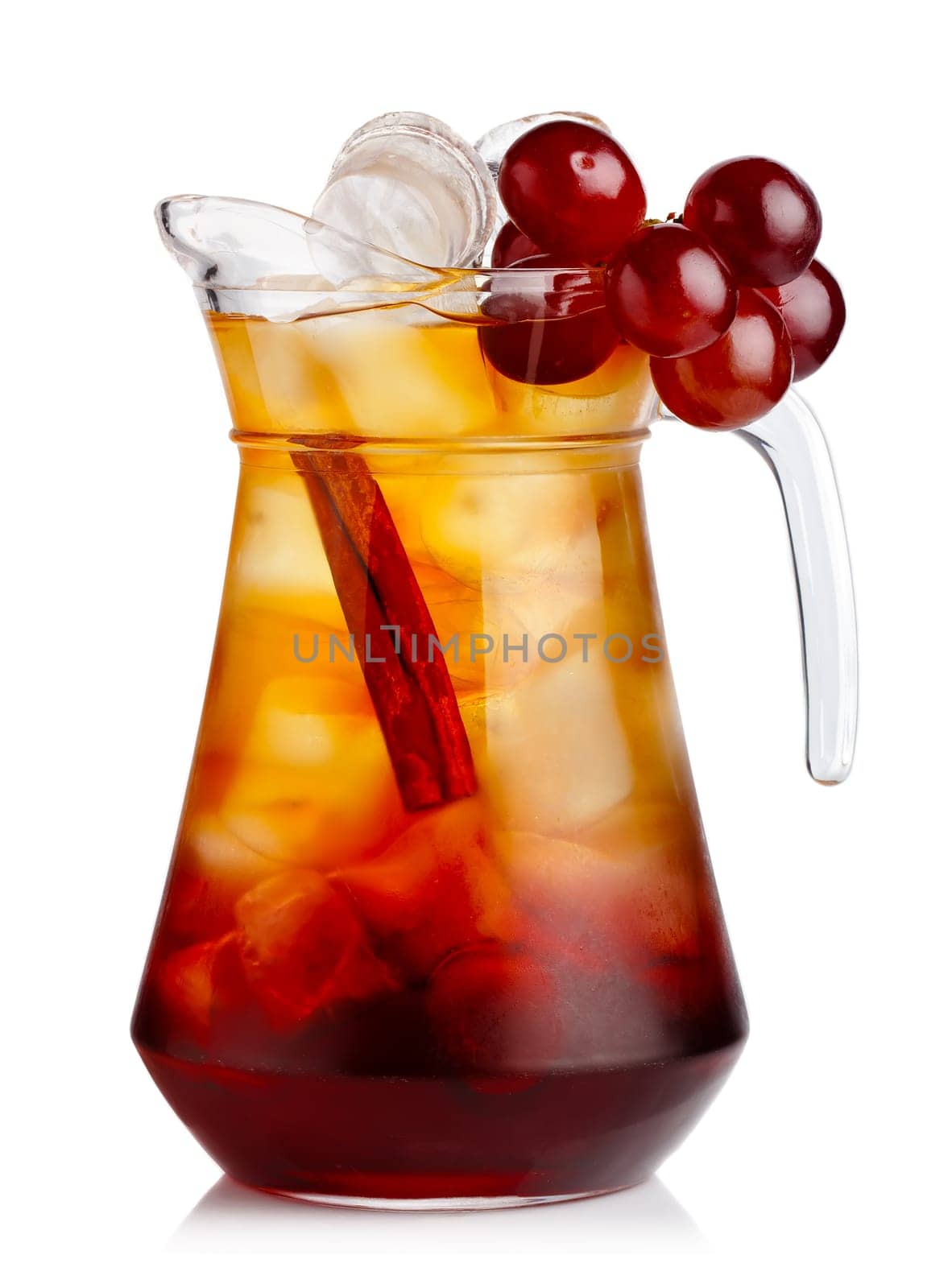 Full jug of fresh nonalcoholic cocktail with grapes and cinnamon stick isolated