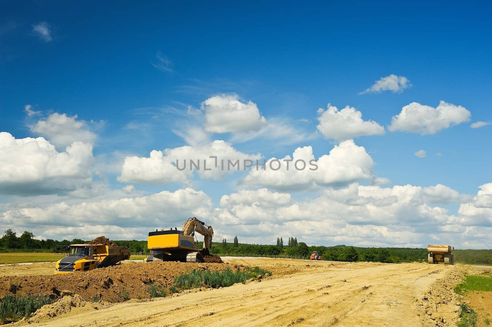 Dump truck and excavator on construction site