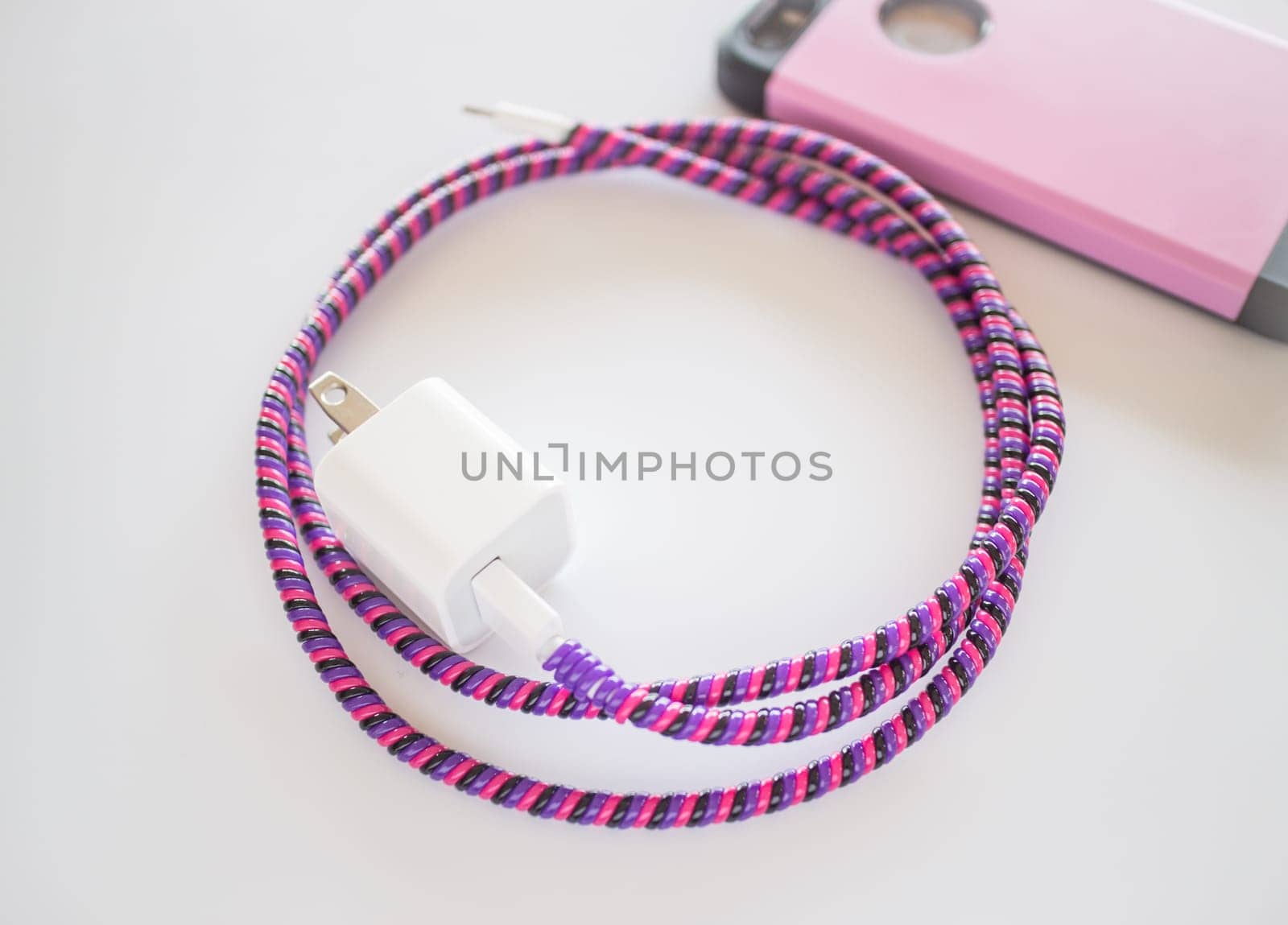 Smart phone charger with plastic cover on white background, stock photo