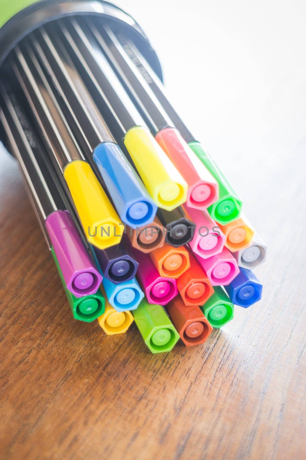 Colorful magic pens on wooden table, stock photo