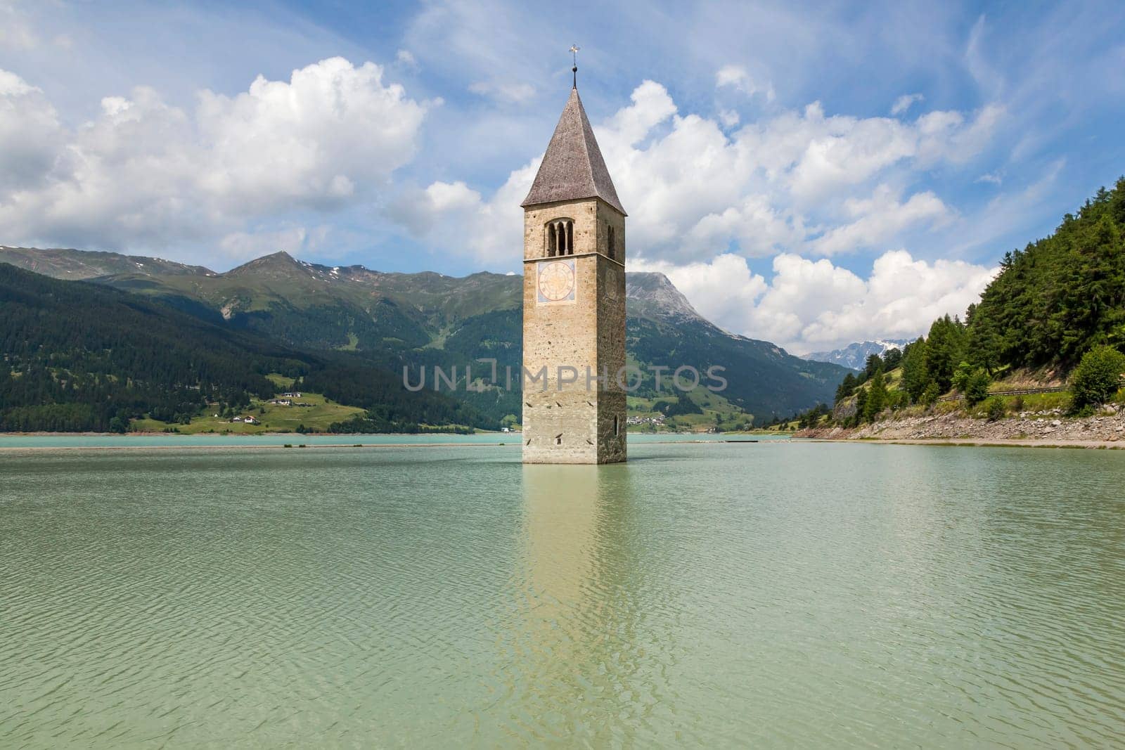 An image of the church tower in the Reschensee Italy