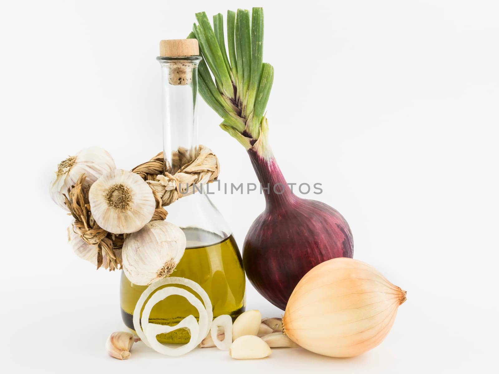 onions, garlic and olive oil on white background
