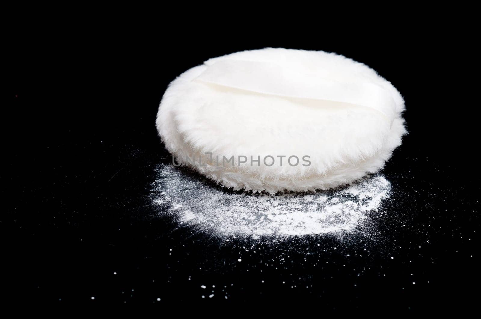 Talcum Powder Puff on a Black Background