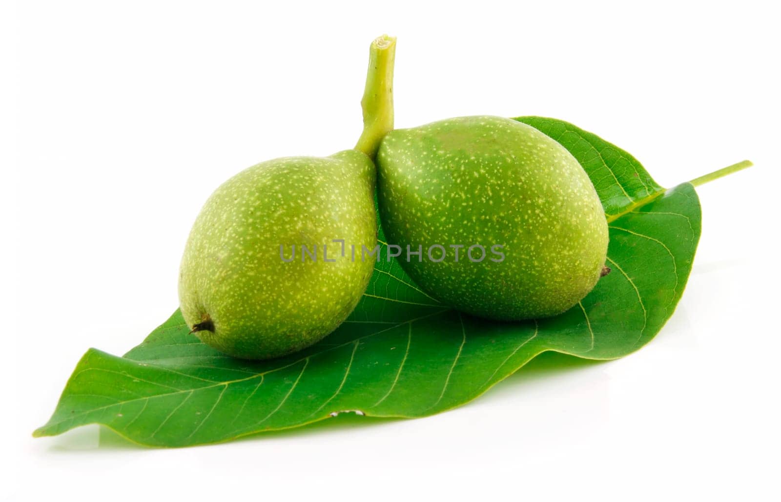 Ripe Broken Walnuts with Green Leaves Isolated on White Background