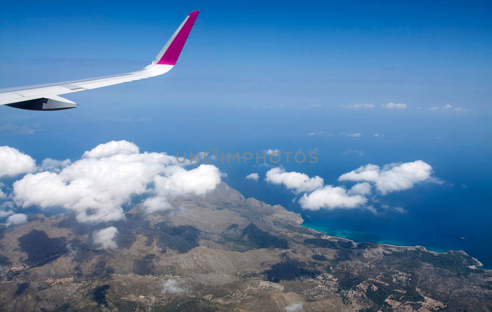 Plane wing and clouds viewed from airplane