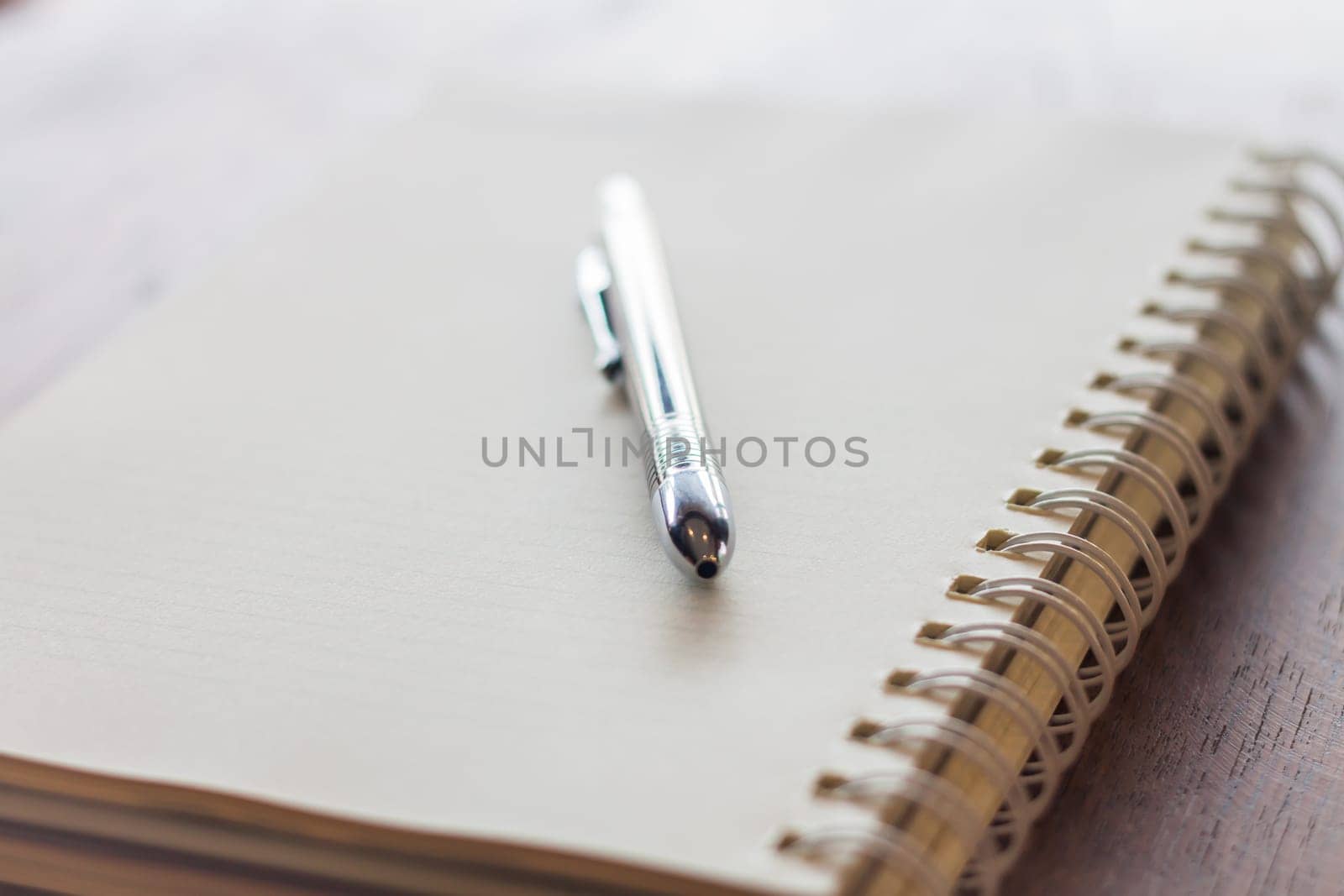 Closeup spiral notebook and pen, stock photo