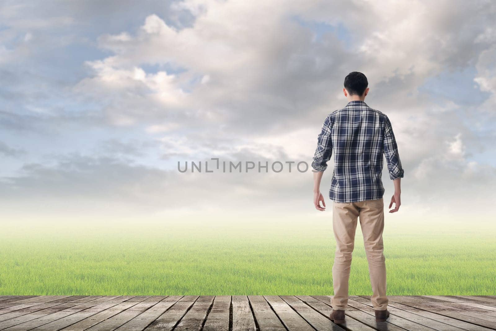 Asian man against grassland with copyspace.