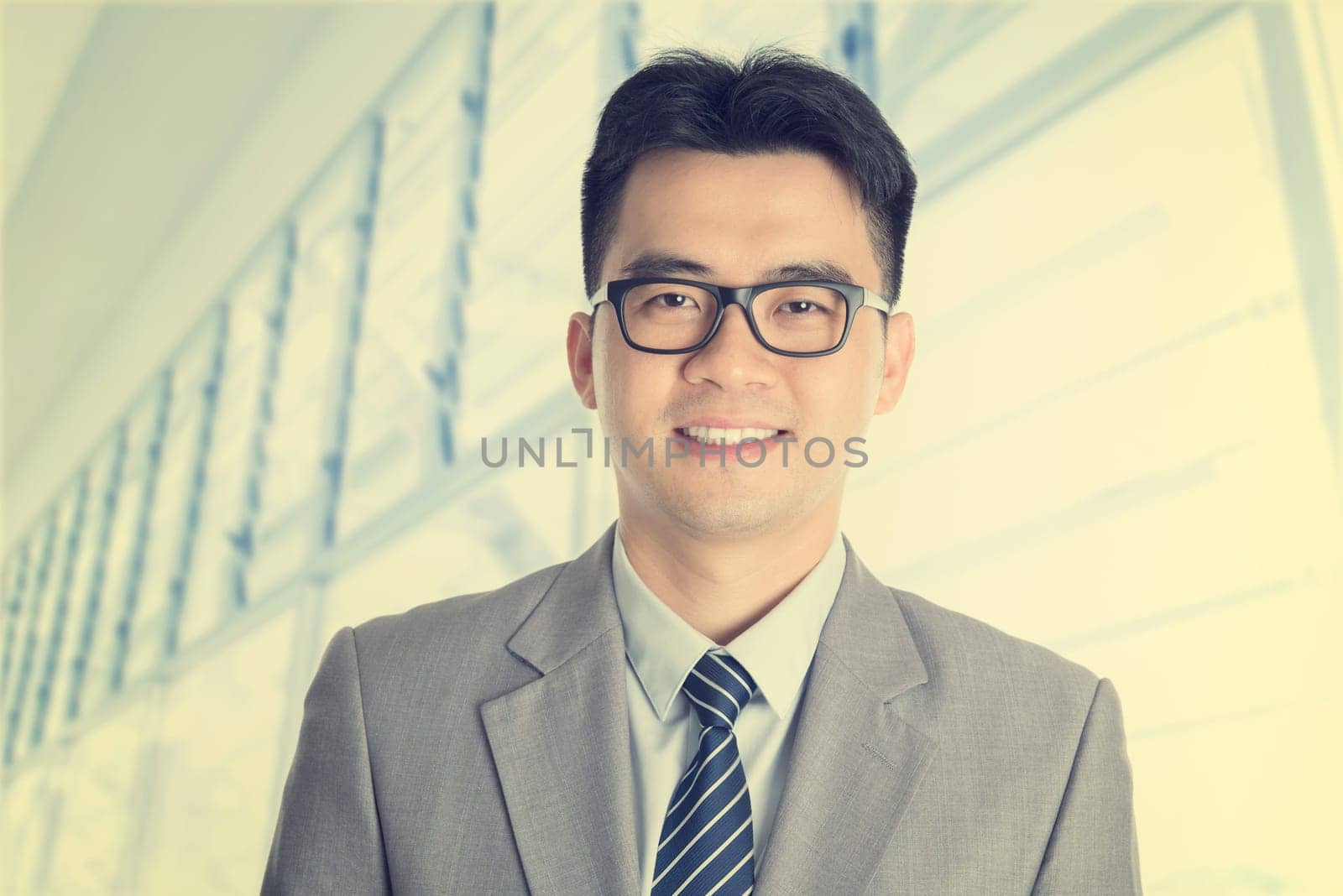 Vintage old style fashion Asian Chinese businessman portrait smiling, office background.