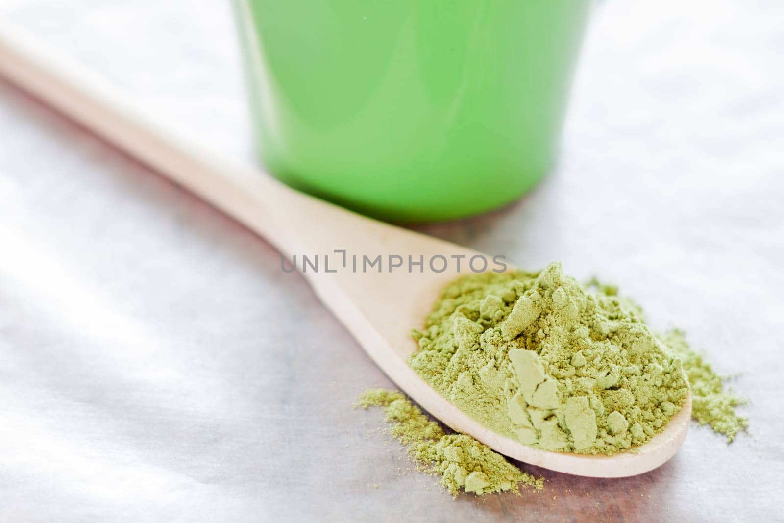 Powdered green tea with wooden spoon, stock photo