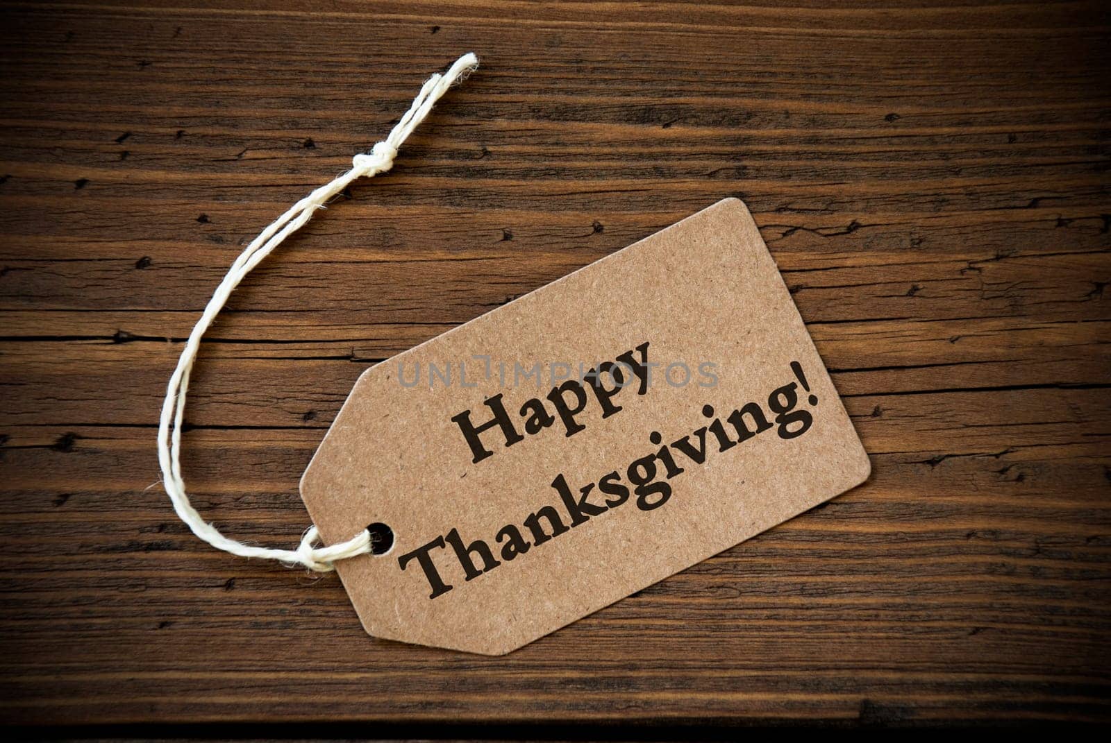 Rustic Natural Label with the Words Happy Thanksgiving on it on Wooden Background