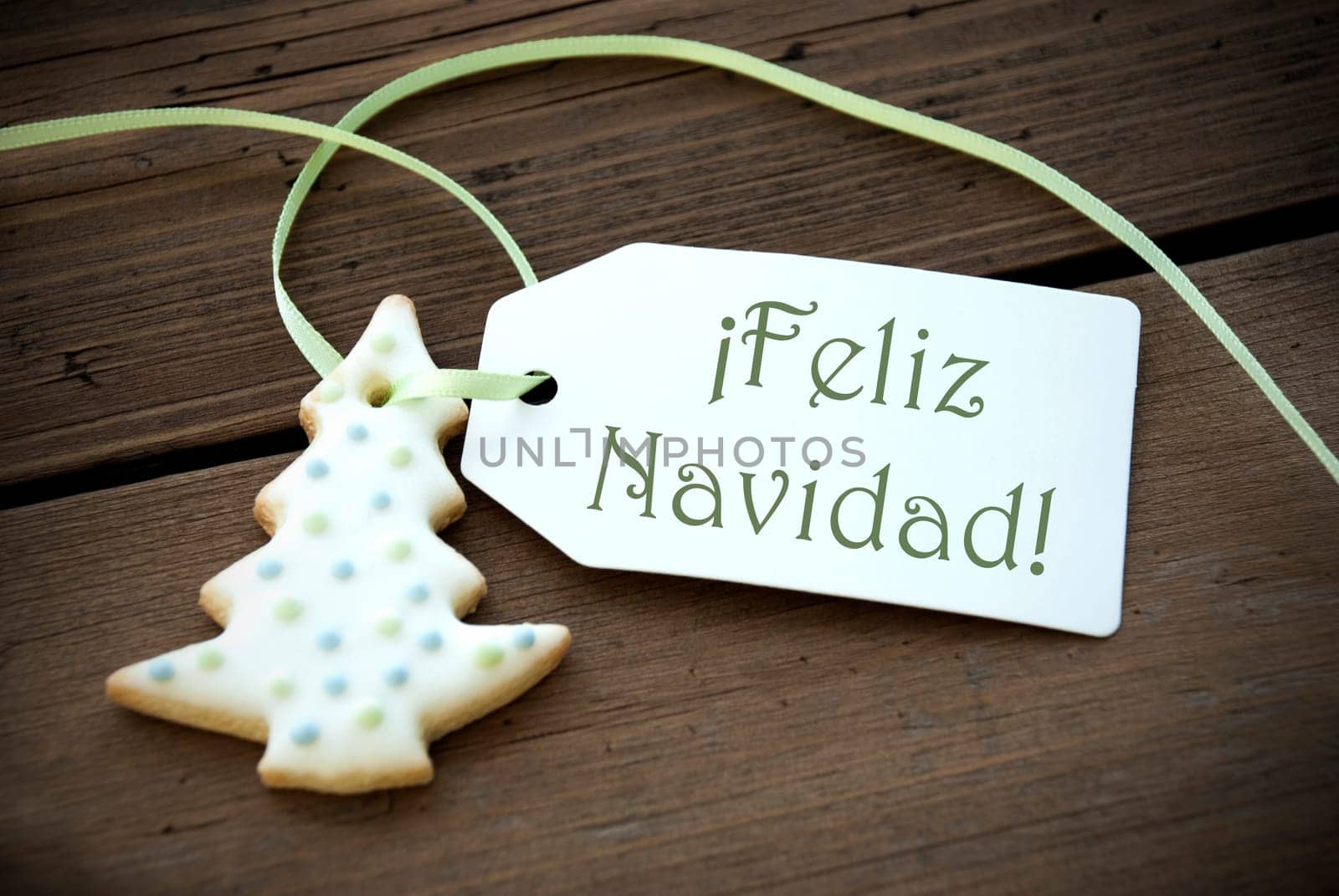 A Christmas Tree Cookie with a Label with the Spanish Words Feliz Navidad on it which means Merry Christmas