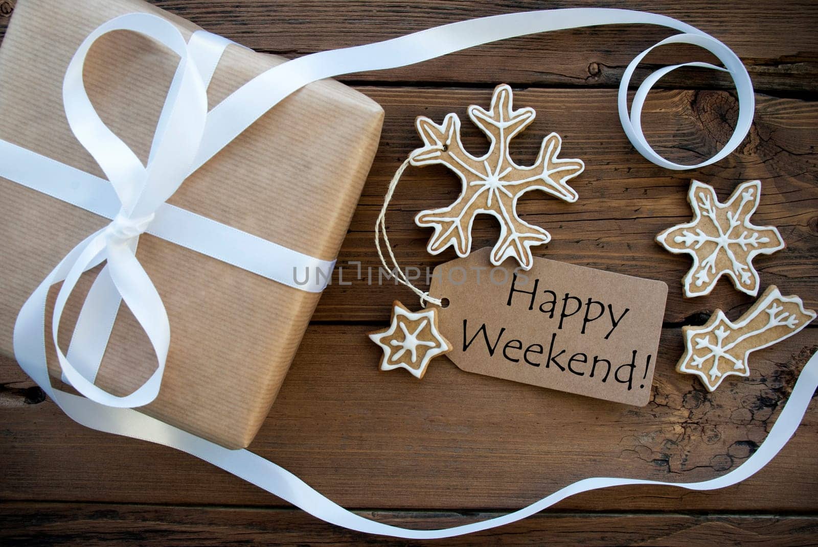 Happy Weekend Greetings on Natural Label on Wood Decorated with Gift Box and Ginger Bread Cookies, Christmas or Winter Background
