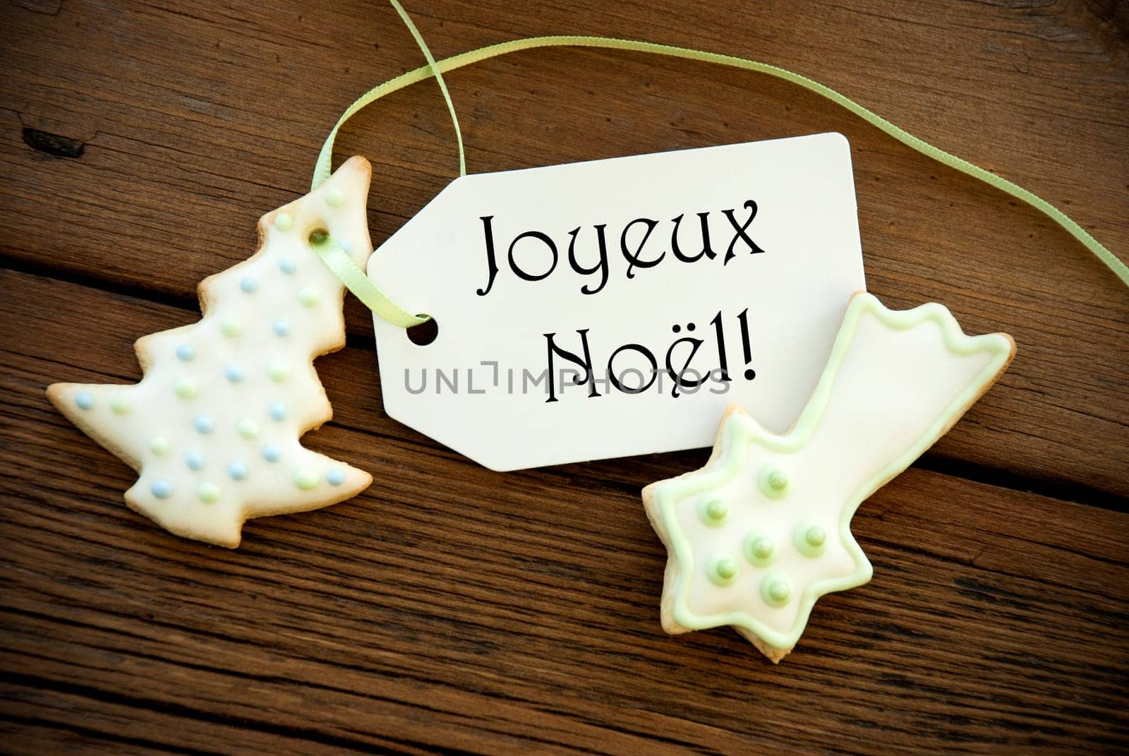 The French Words Joyeux Noël, which means Merry Christmas, on a Label with Christmas Cookies