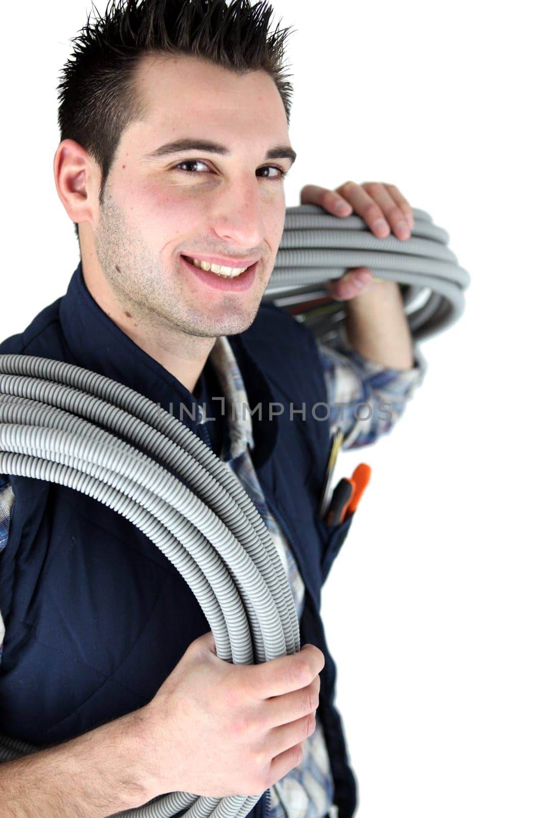 Electrician stood with corrugated cabling