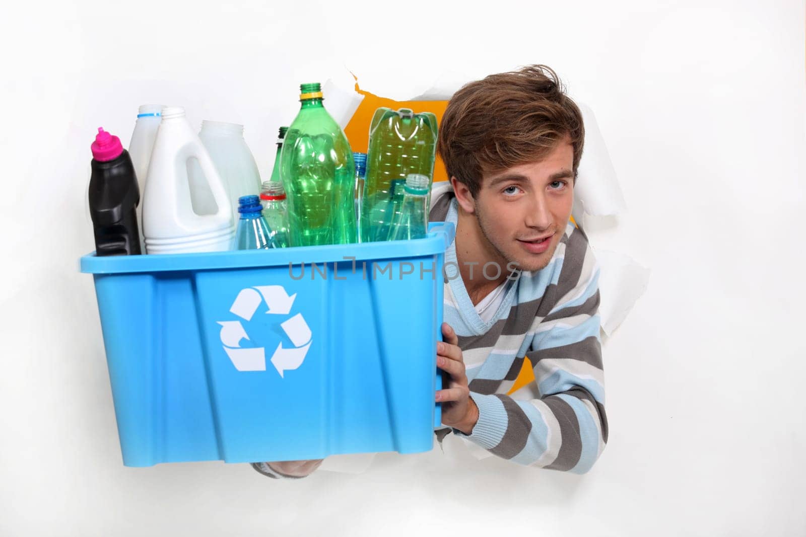 Man holding crate of bottles to be recycled