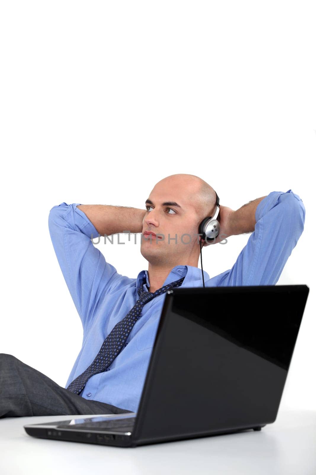 Office worker listening to music through headphones