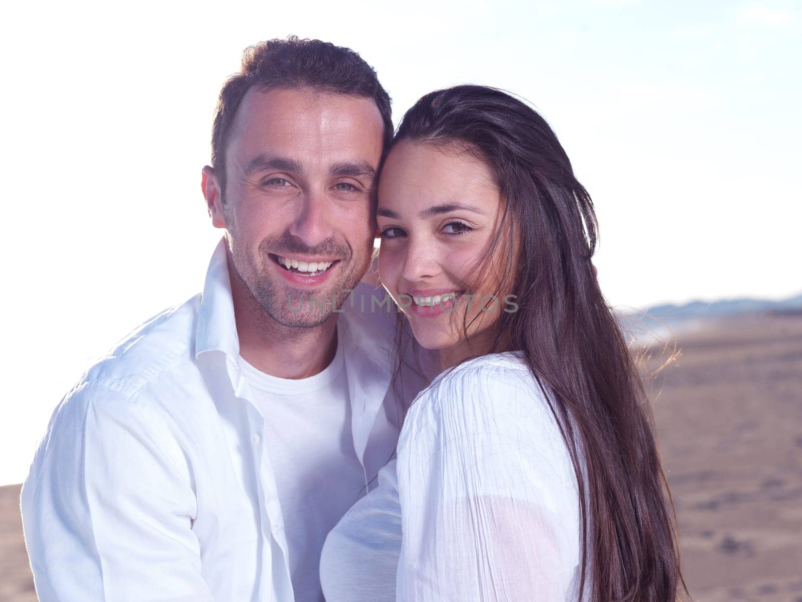 happy young romantic couple in love have fun on beautiful beach at beautiful summer day