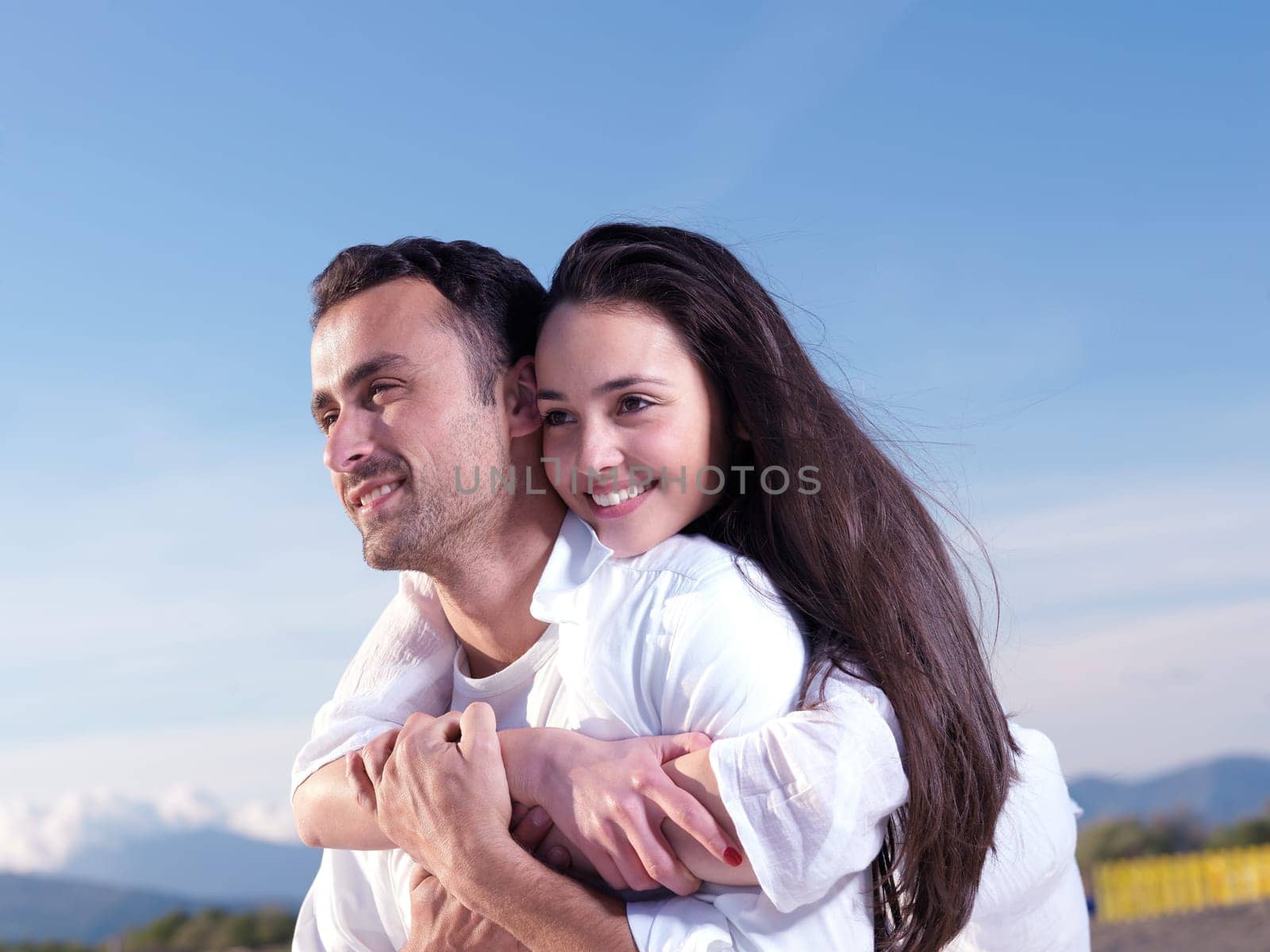 happy young romantic couple in love have fun on beautiful beach at beautiful summer day