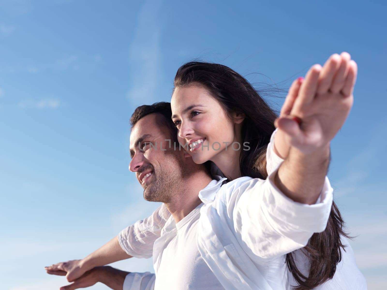 happy young romantic couple in love have fun on beautiful beach at beautiful summer day