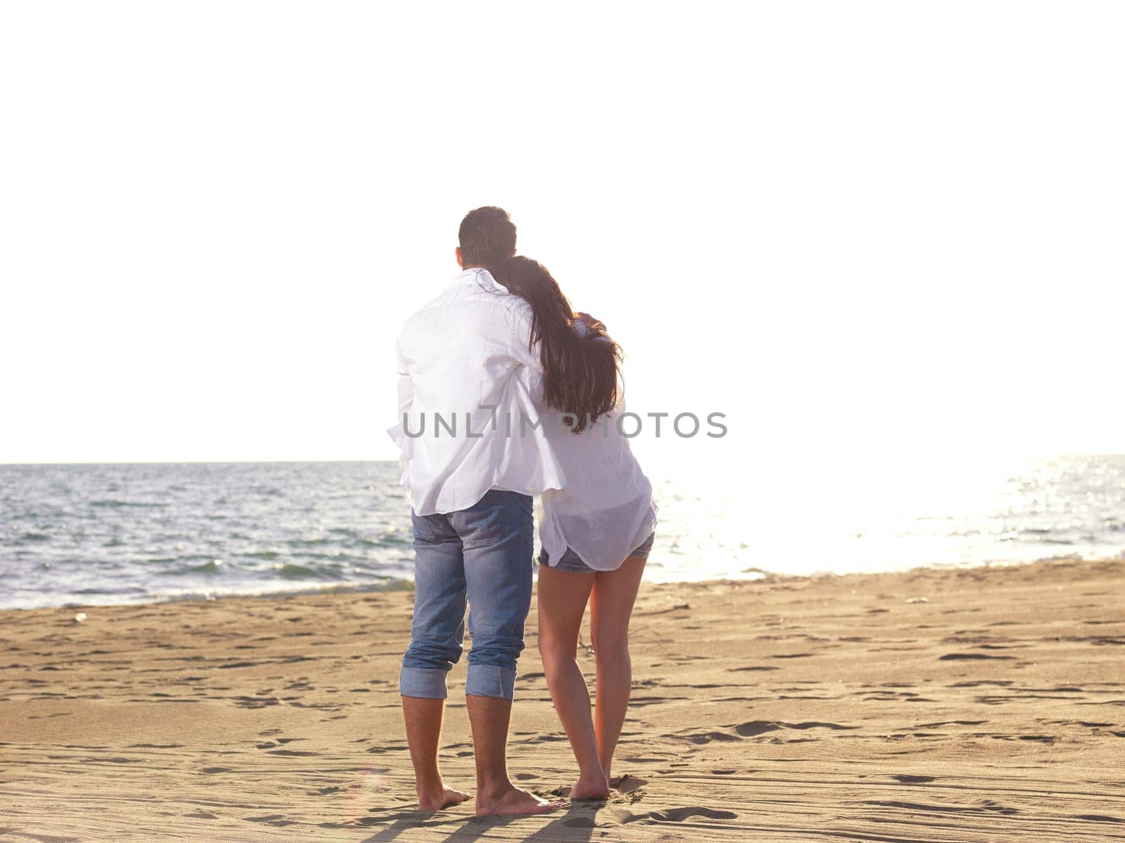 happy young romantic couple in love have fun on beautiful beach at beautiful summer day