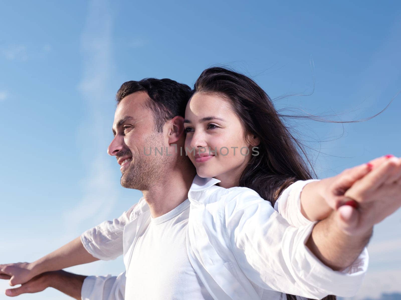 happy young romantic couple in love have fun on beautiful beach at beautiful summer day